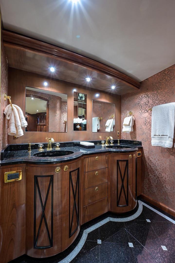 a bathroom with a sink and a mirror aboard BLACK SHADOW Yacht for Sale