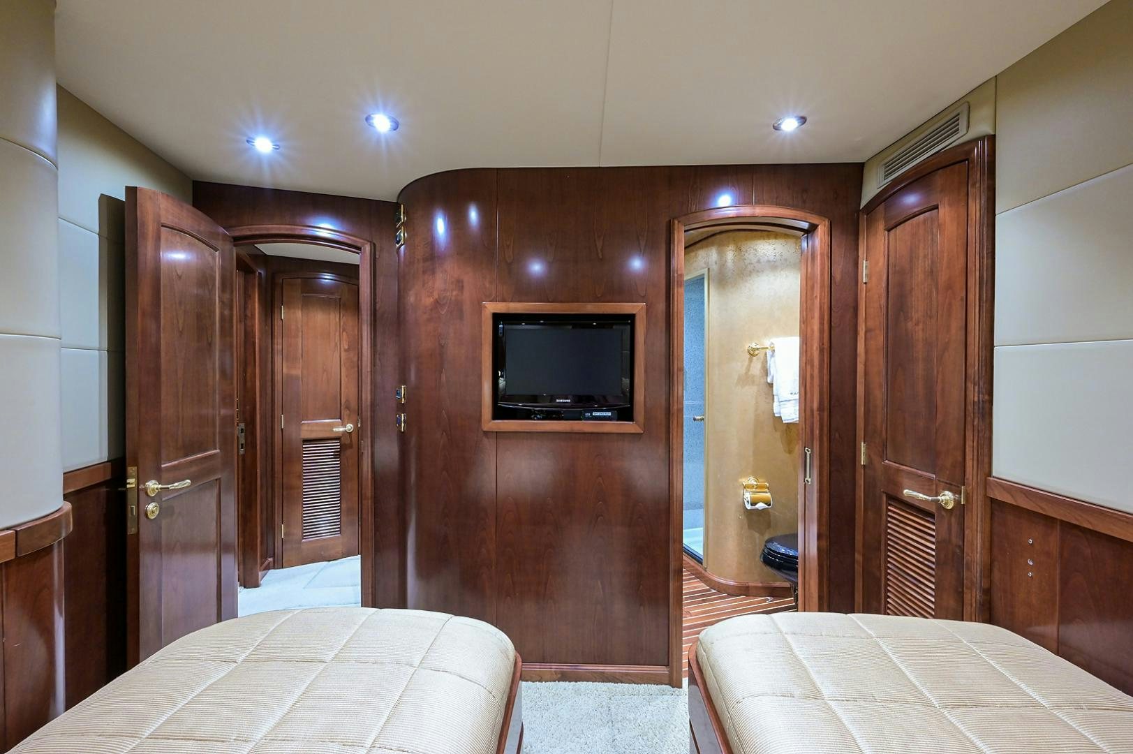 a hotel room with a bed and a television aboard BLACK SHADOW Yacht for Sale