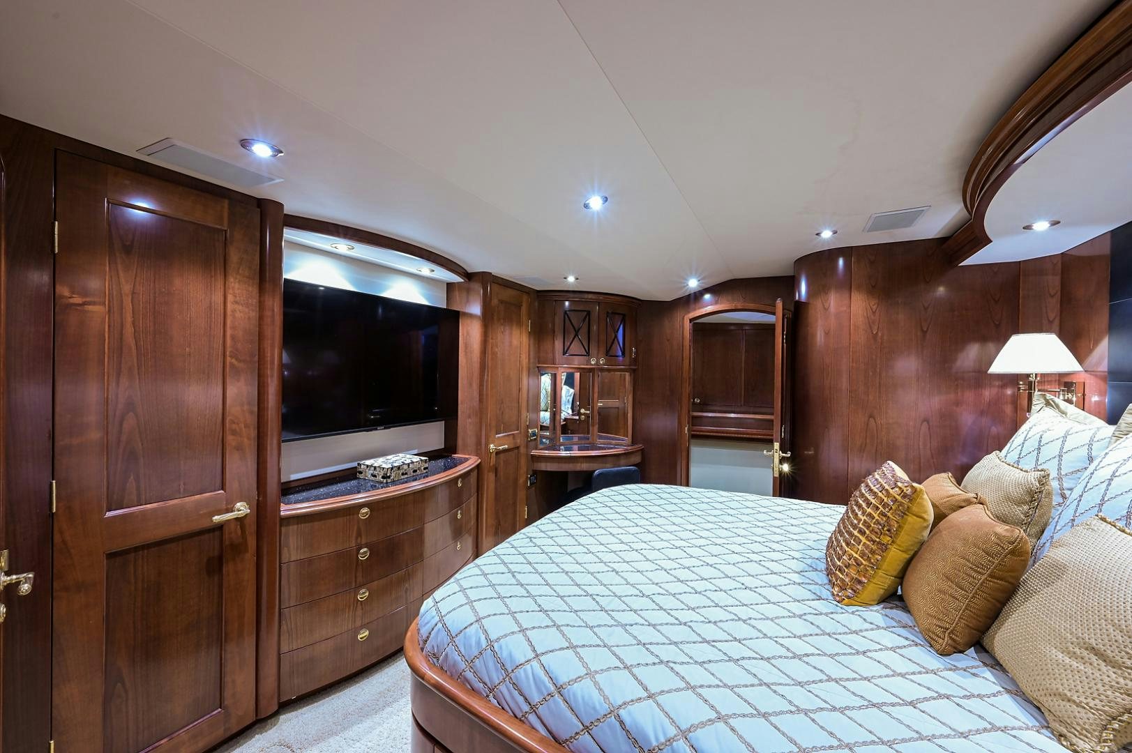 a bedroom with a bed and a television aboard BLACK SHADOW Yacht for Sale