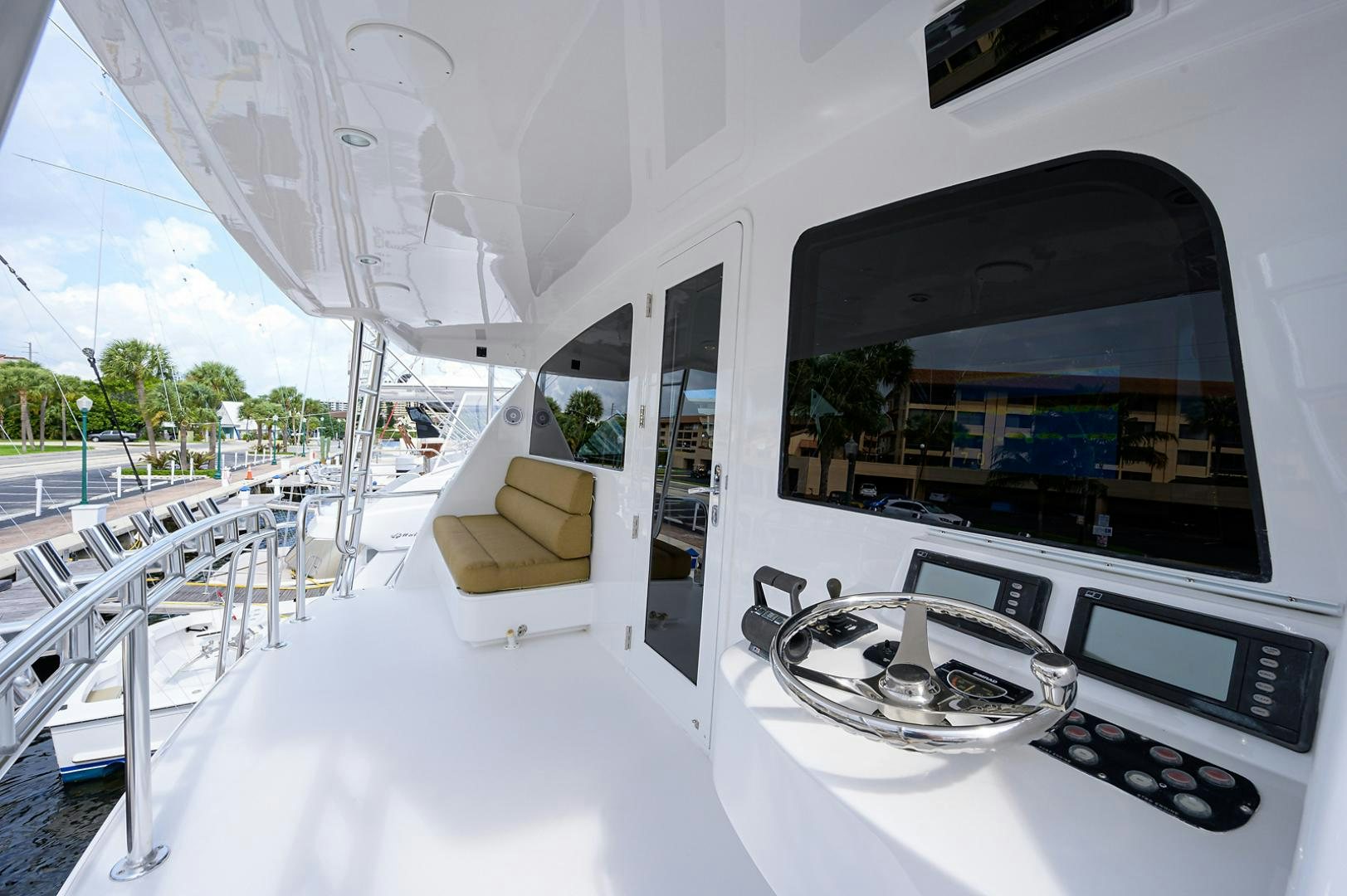 a white room with a large window and a white table and chairs aboard BLACK SHADOW Yacht for Sale