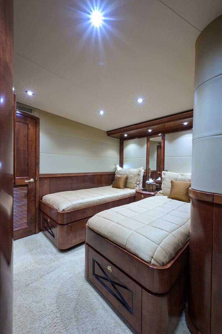a bedroom with a bed and a window aboard BLACK SHADOW Yacht for Sale
