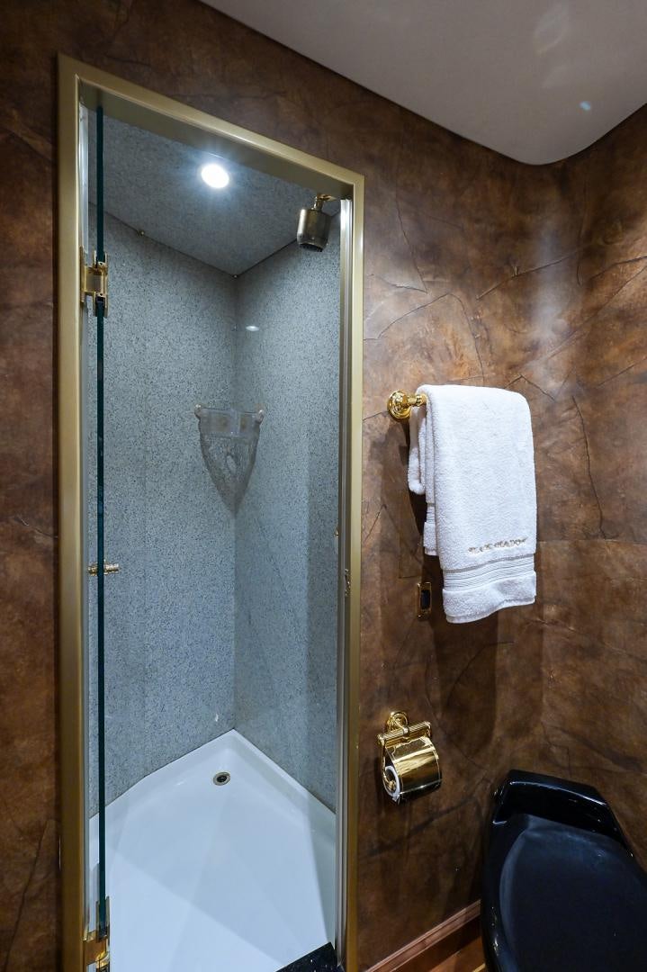a bathroom with a shower and a sink aboard BLACK SHADOW Yacht for Sale