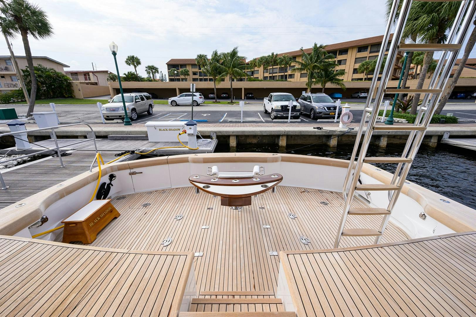 a deck with a table and chairs aboard BLACK SHADOW Yacht for Sale