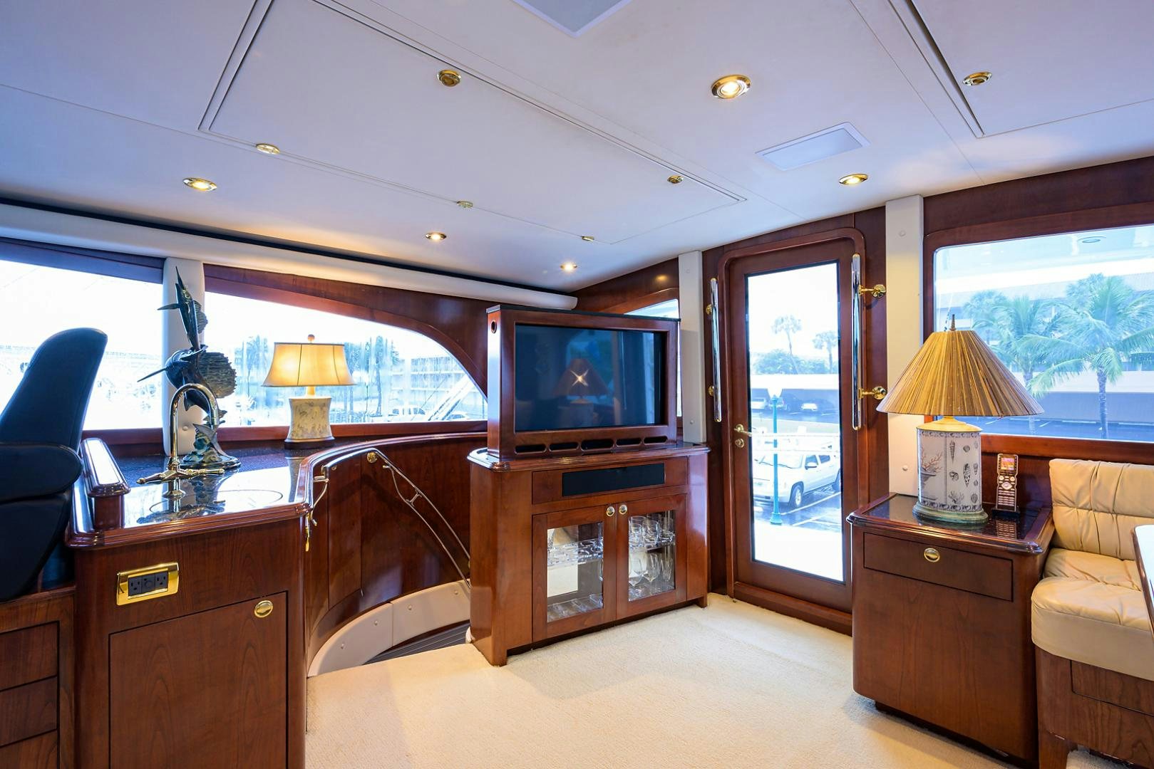 a living room with a tv and a dresser aboard BLACK SHADOW Yacht for Sale