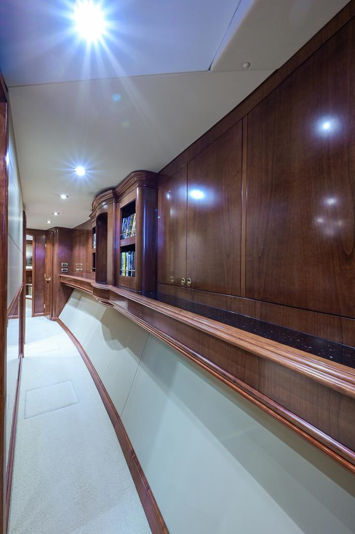 a long hallway with a glass door aboard BLACK SHADOW Yacht for Sale