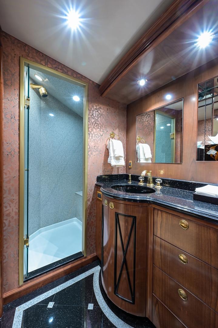 a bathroom with a sink and a mirror aboard BLACK SHADOW Yacht for Sale
