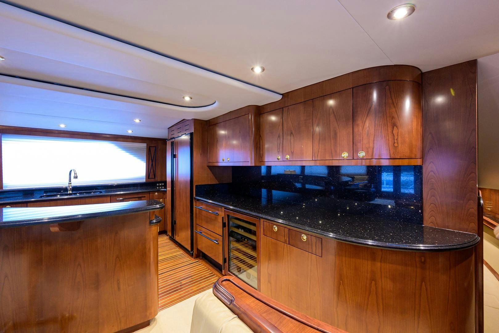 a kitchen with wooden cabinets aboard BLACK SHADOW Yacht for Sale