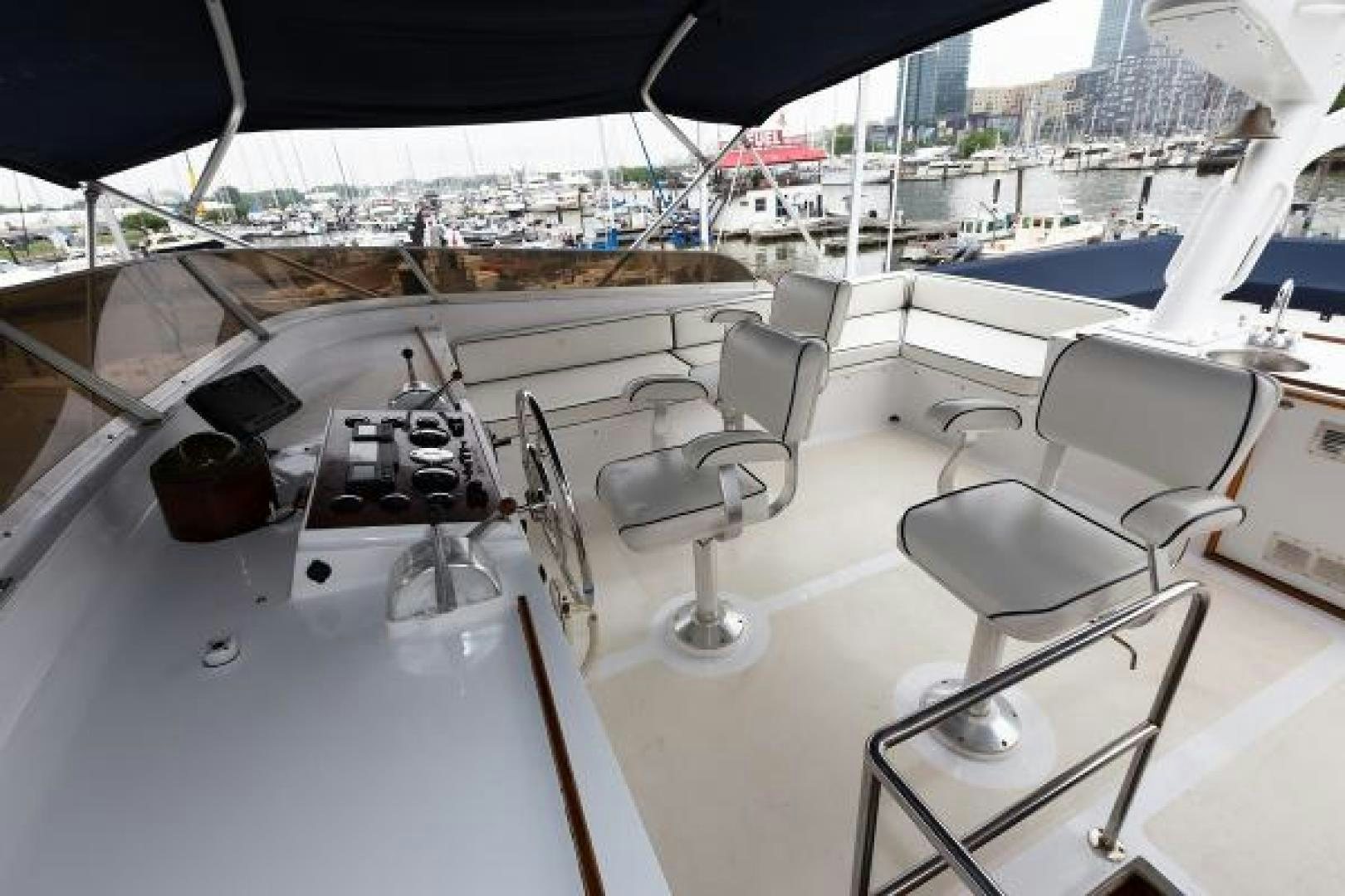 a large white yacht with chairs and tables aboard No Name Yacht for Sale