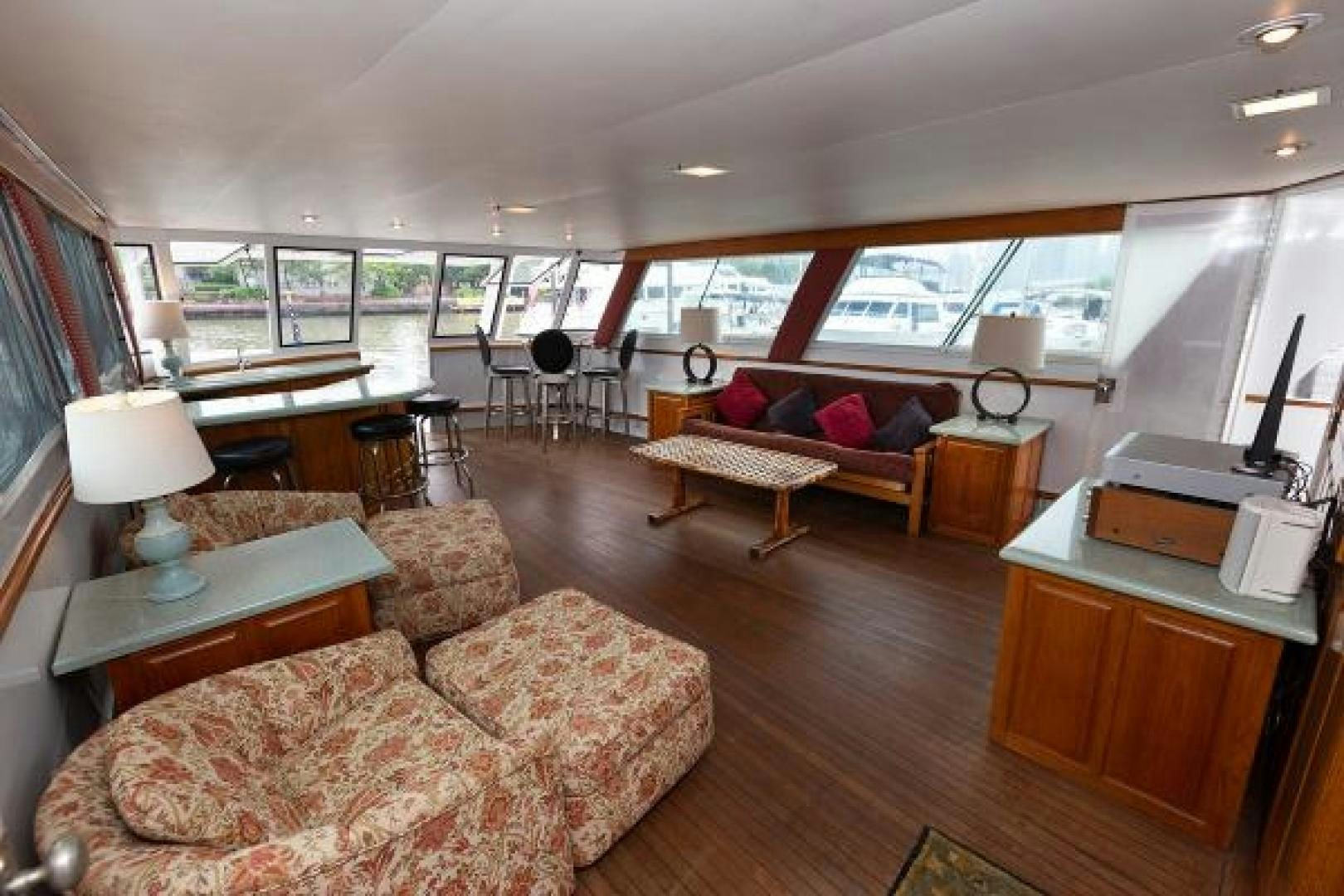 a living room with a couch and a table aboard No Name Yacht for Sale