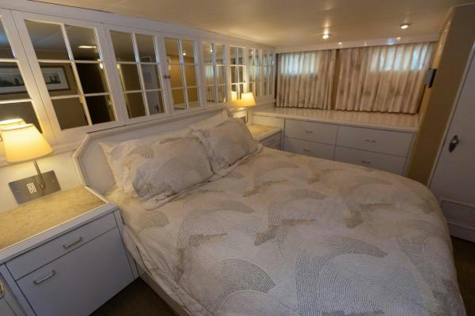 a bed with white sheets aboard No Name Yacht for Sale
