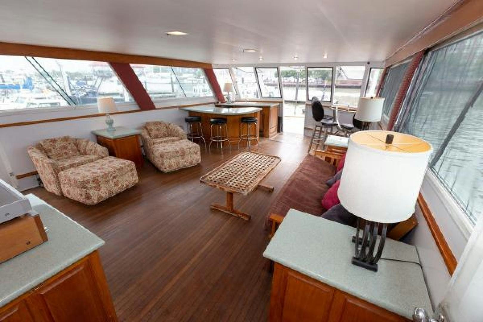 a living room with a table and chairs aboard No Name Yacht for Sale