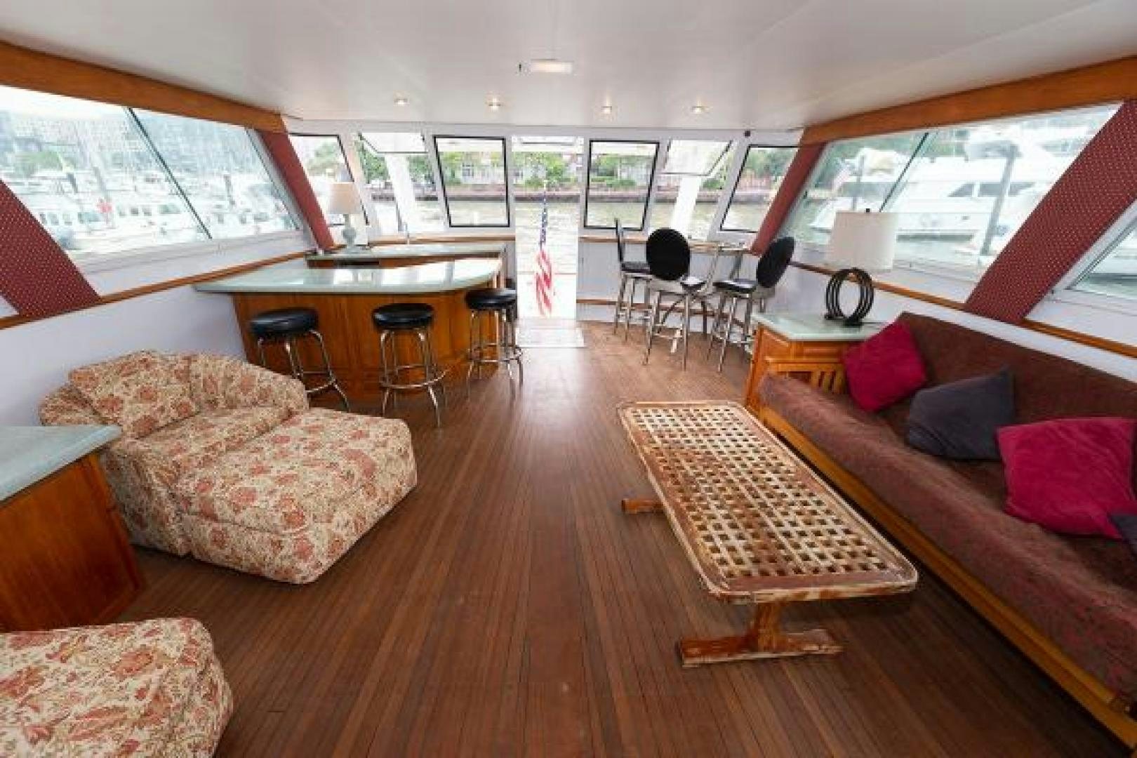a living room with a couch and a table aboard No Name Yacht for Sale