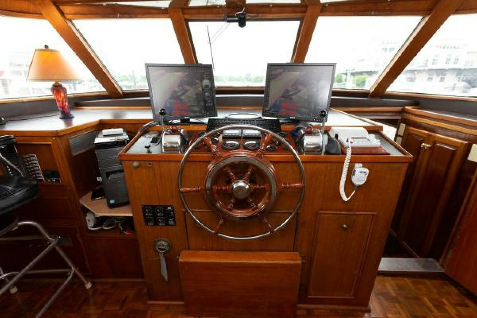 a wooden desk with a computer and a large speaker aboard No Name Yacht for Sale