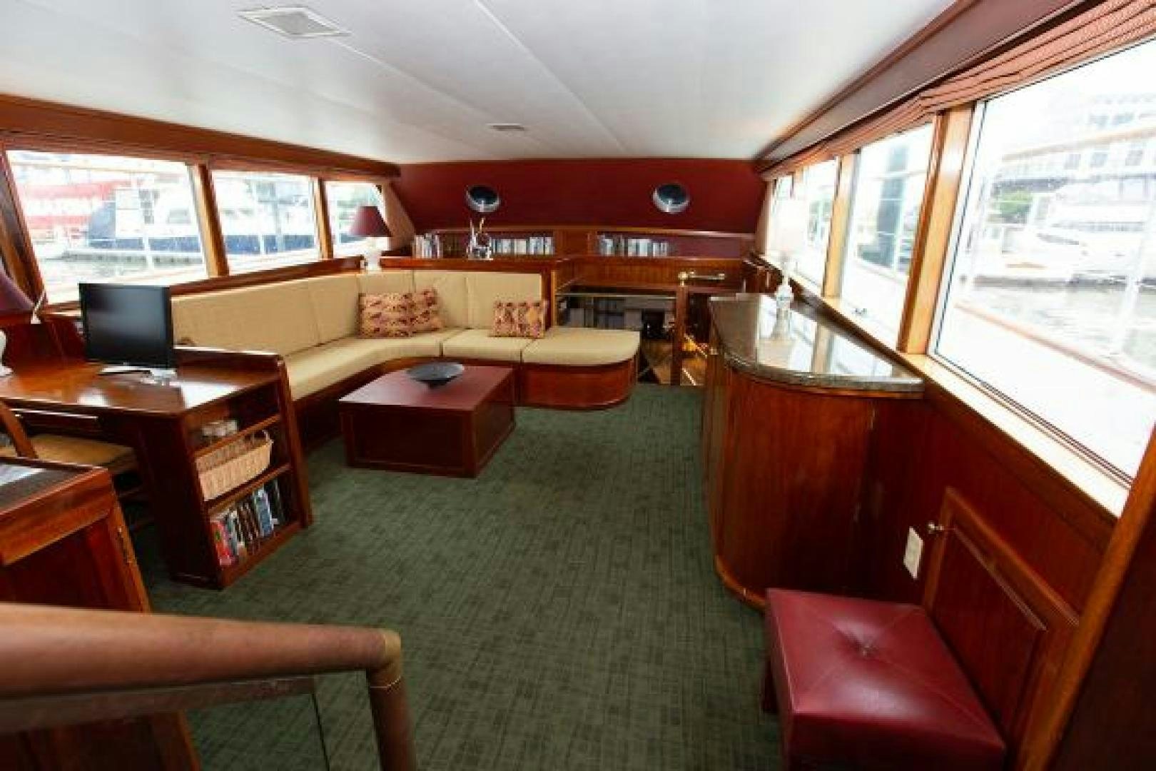 a large room with a couch and a table aboard No Name Yacht for Sale