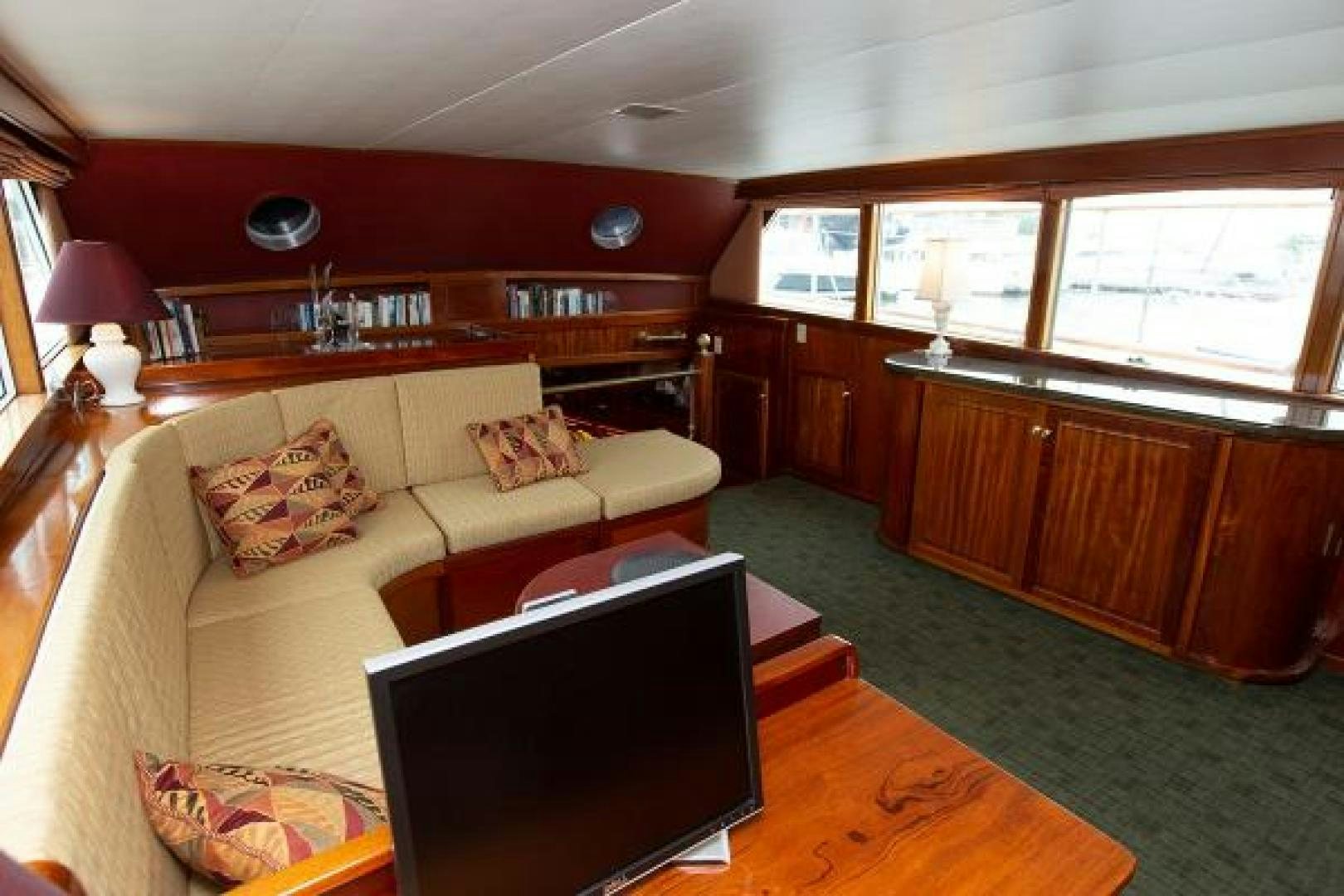 a living room with a couch and a tv aboard No Name Yacht for Sale