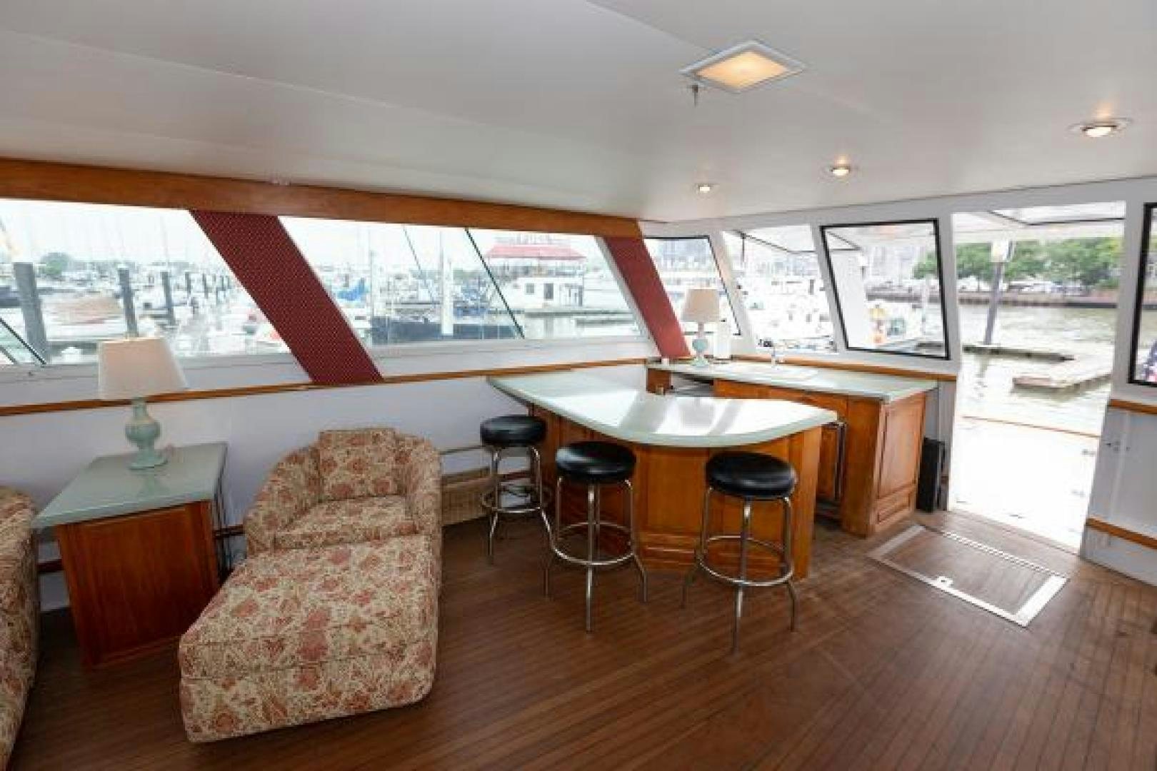 a living room with a table and chairs aboard No Name Yacht for Sale