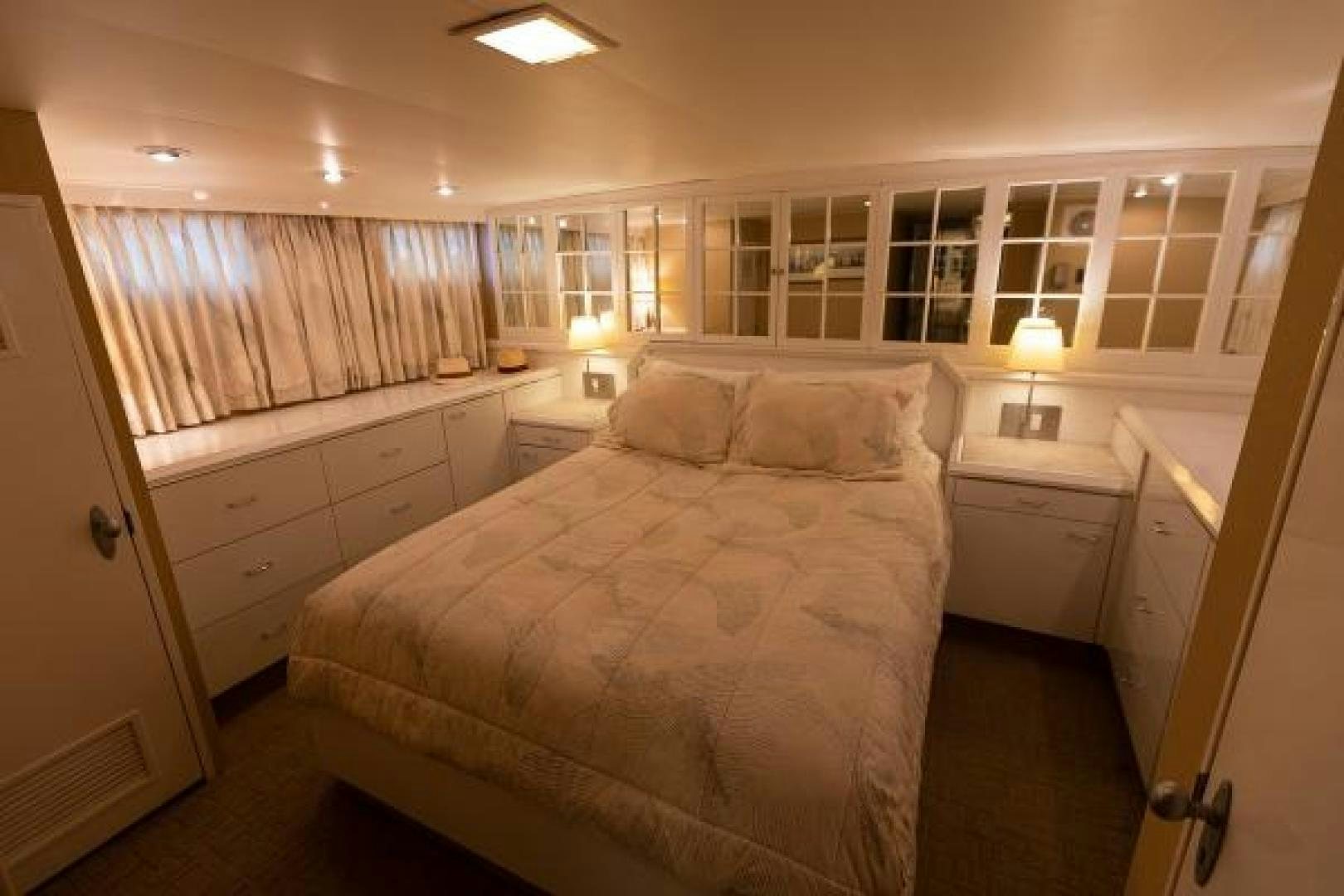 a bedroom with a bed and a window aboard No Name Yacht for Sale