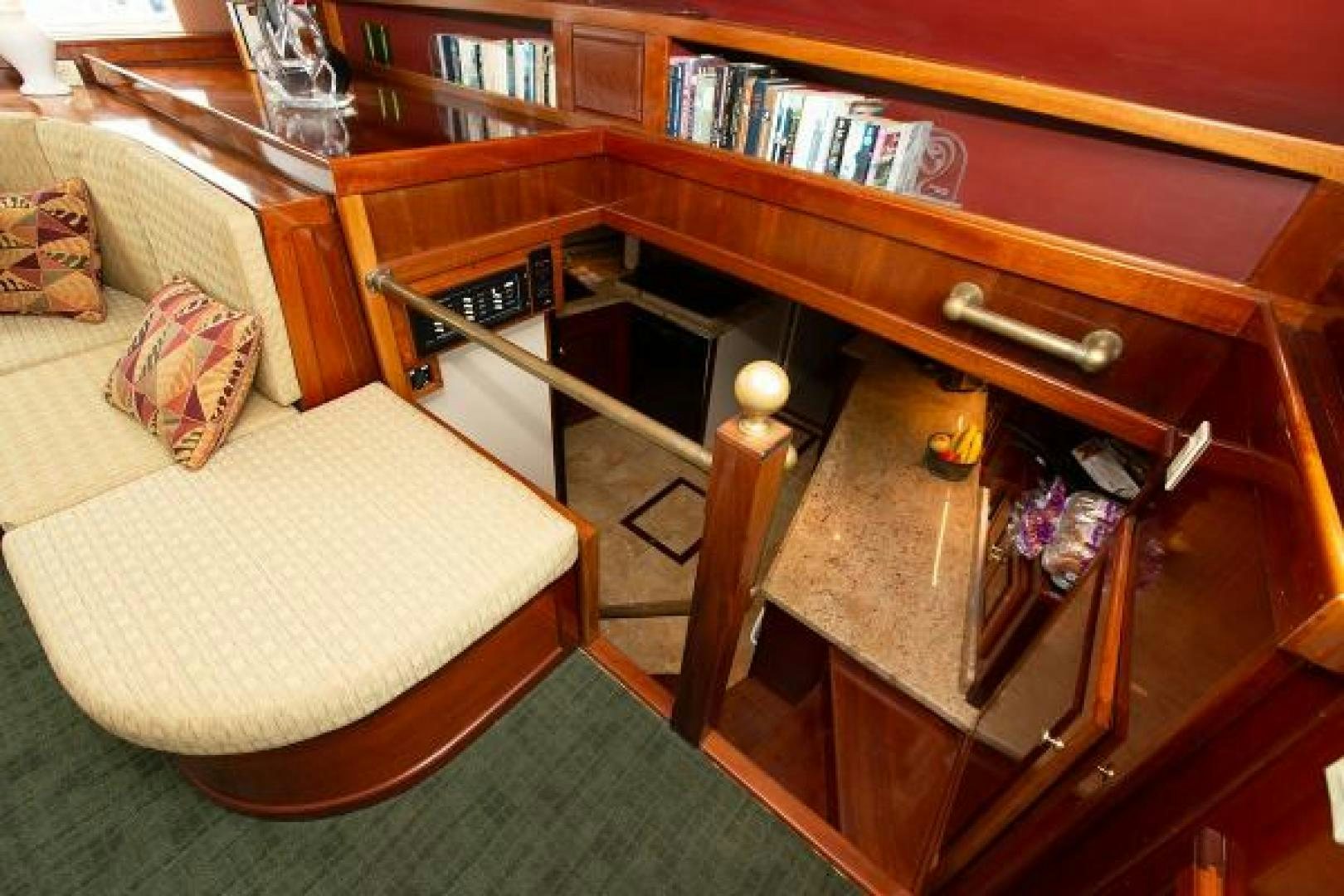 a wooden cabinet with a bench aboard No Name Yacht for Sale