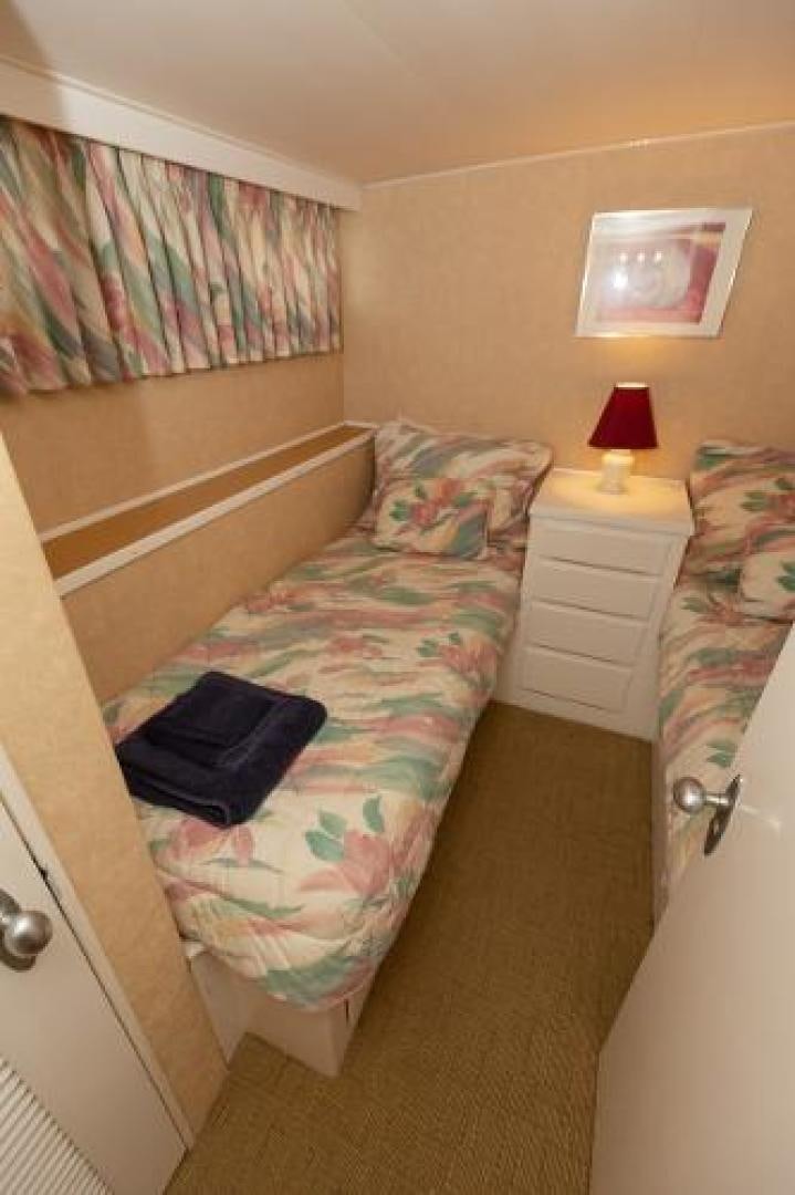 a bed with a pillow on it aboard No Name Yacht for Sale