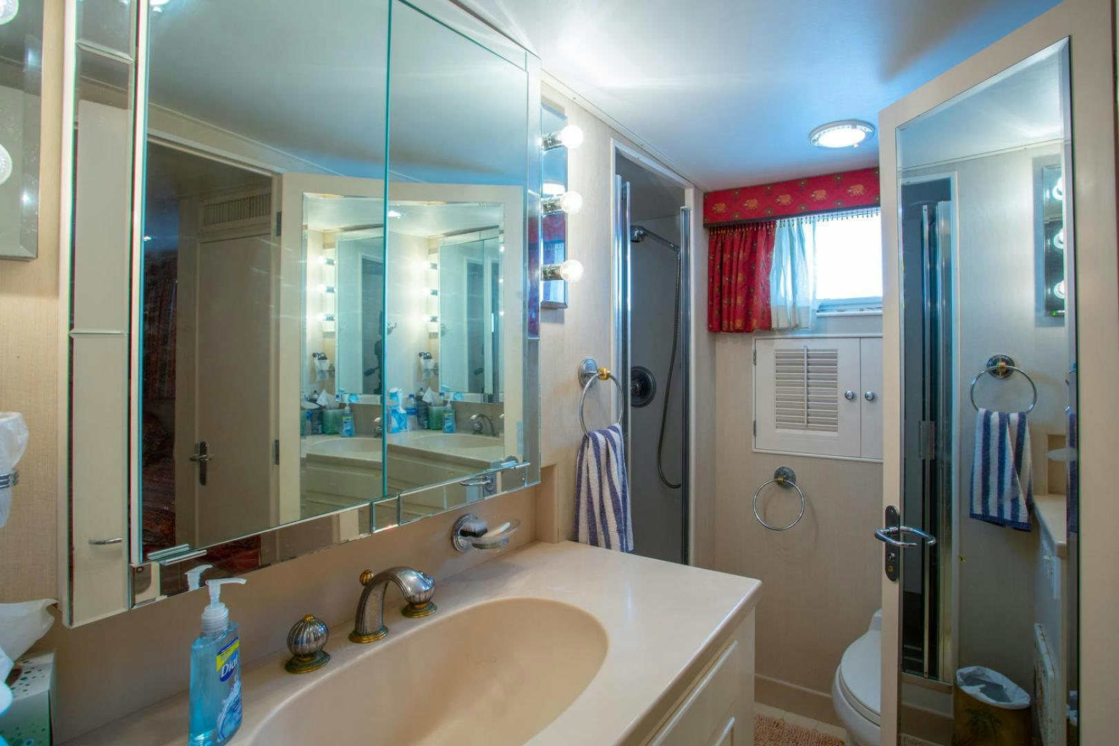 a bathroom with a large mirror aboard HIGH MILEAGE Yacht for Sale
