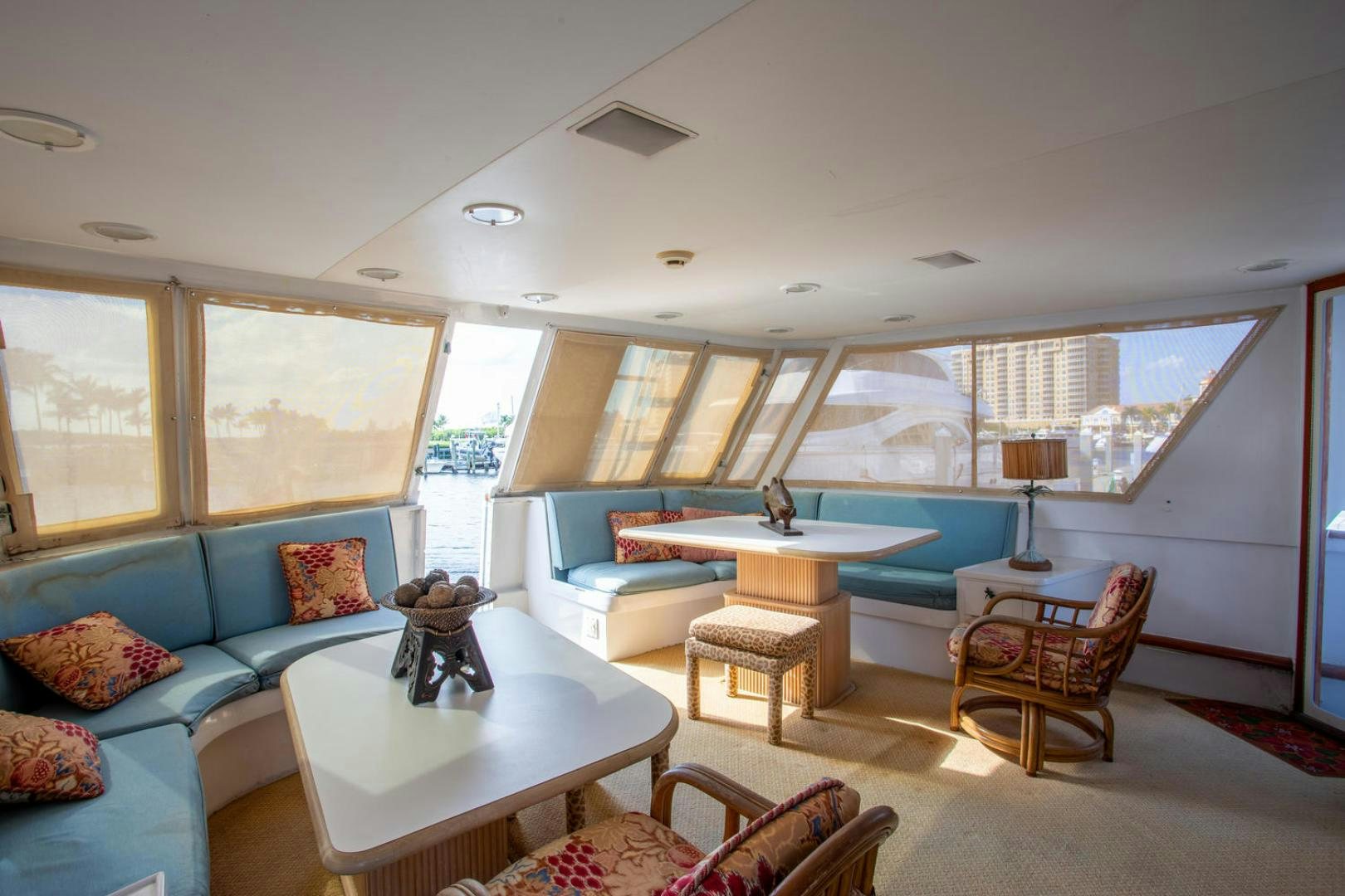 a living room with a blue couch and a table aboard HIGH MILEAGE Yacht for Sale