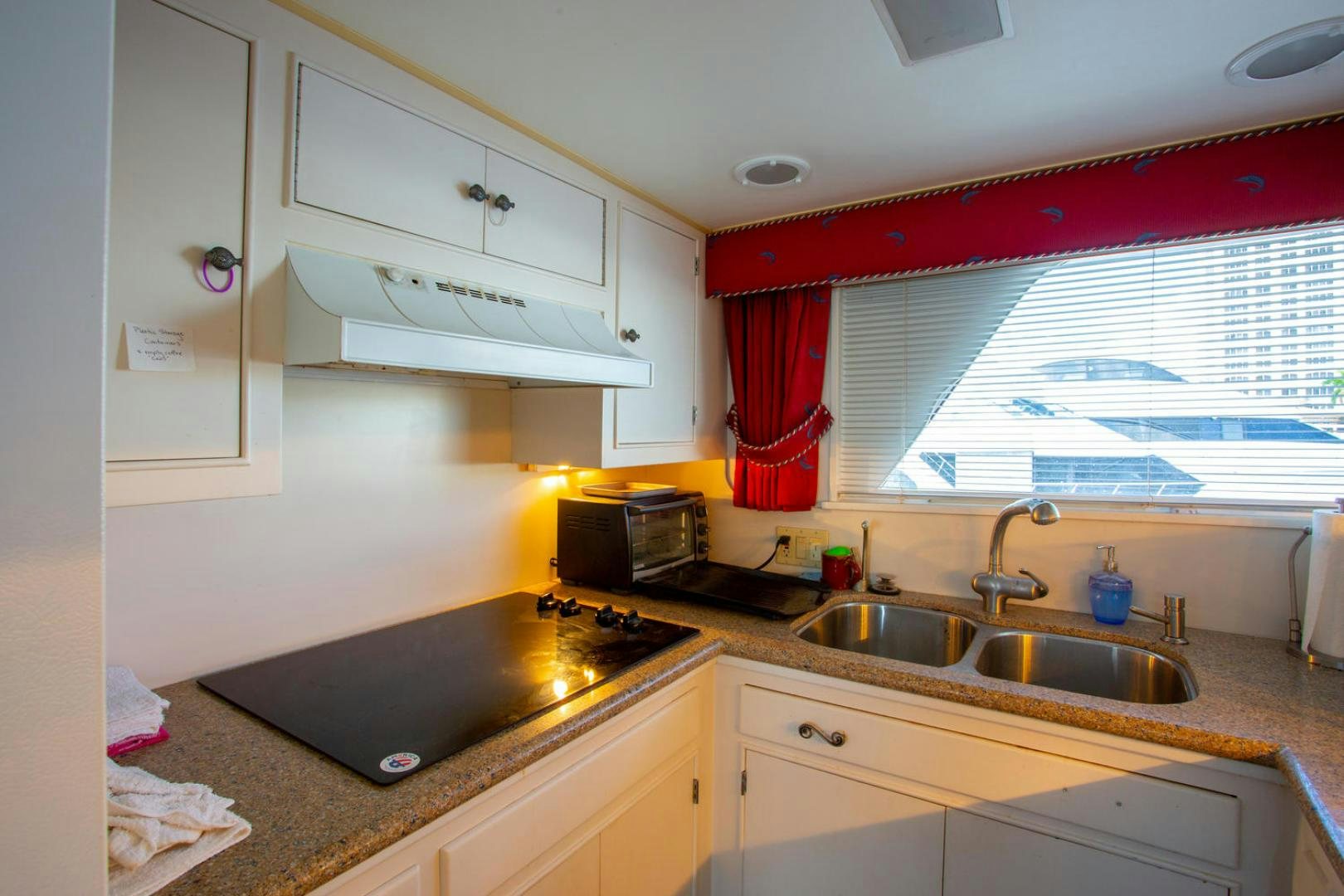 a kitchen with white cabinets aboard HIGH MILEAGE Yacht for Sale