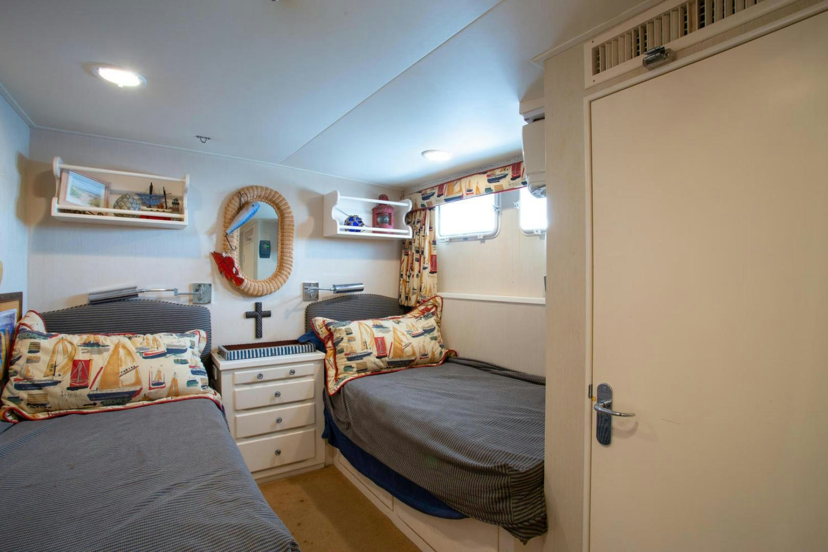 a bedroom with a mirror and a bed aboard HIGH MILEAGE Yacht for Sale