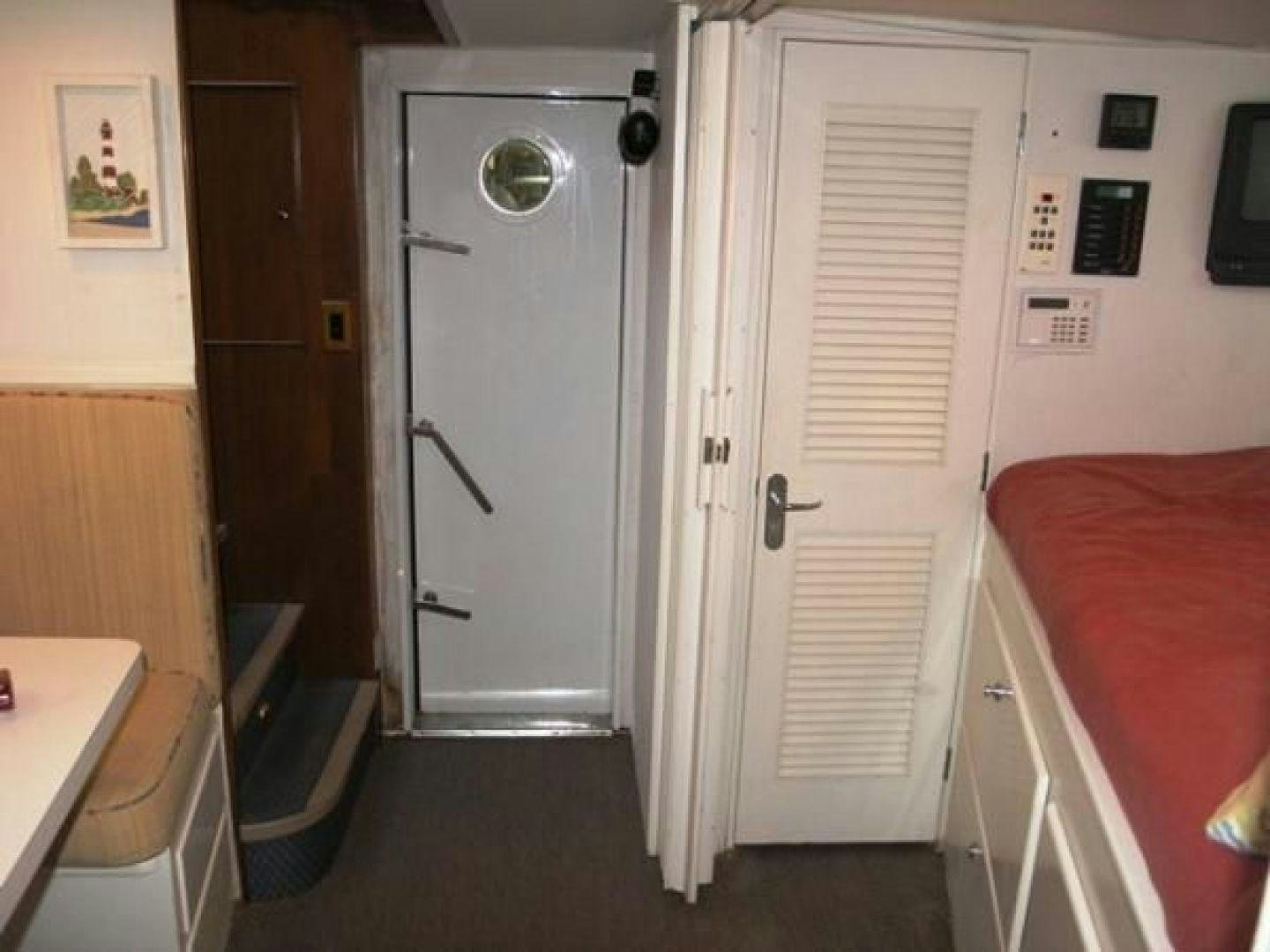 a room with a door and a sink aboard HIGH MILEAGE Yacht for Sale