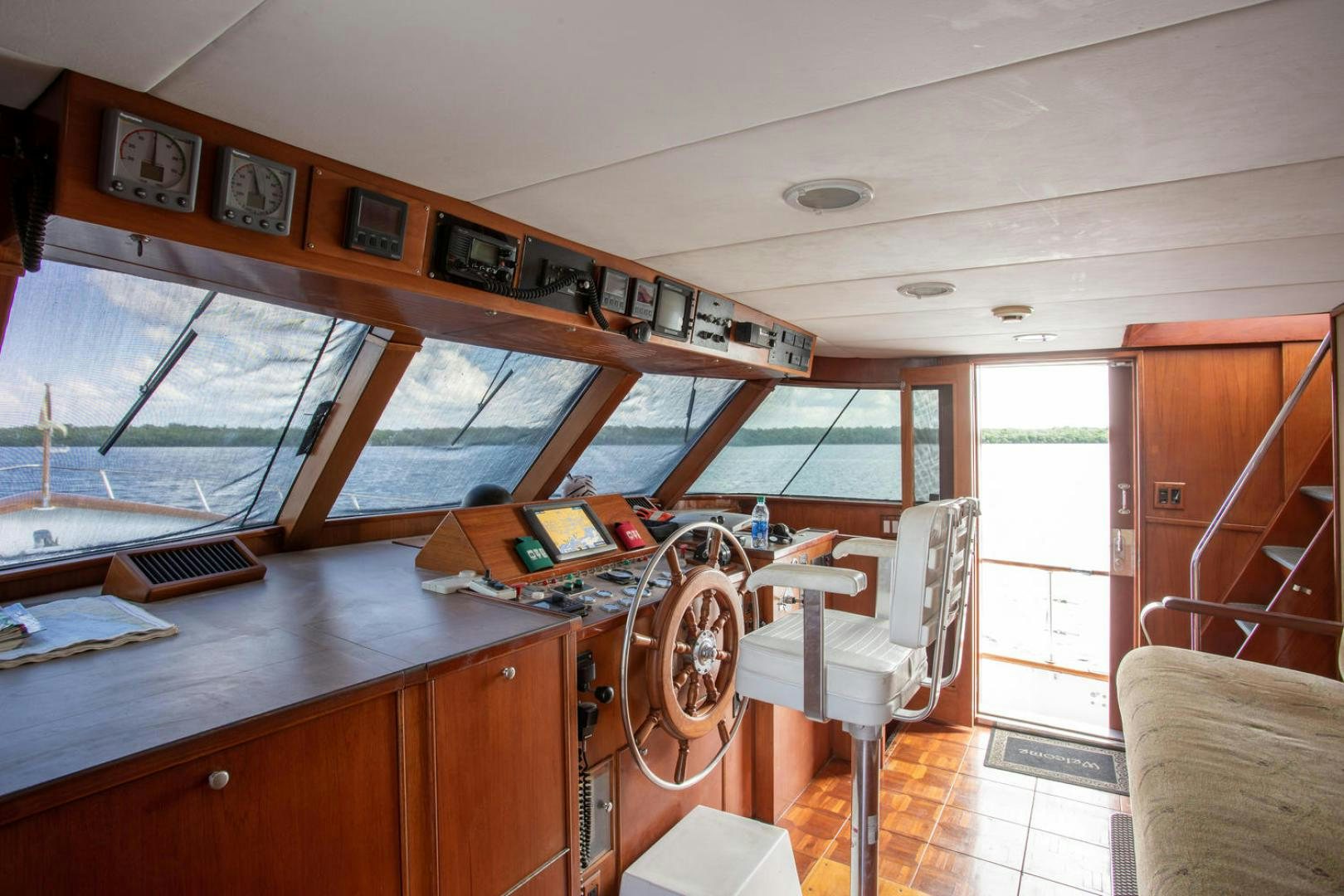 a room with a table and chairs aboard HIGH MILEAGE Yacht for Sale