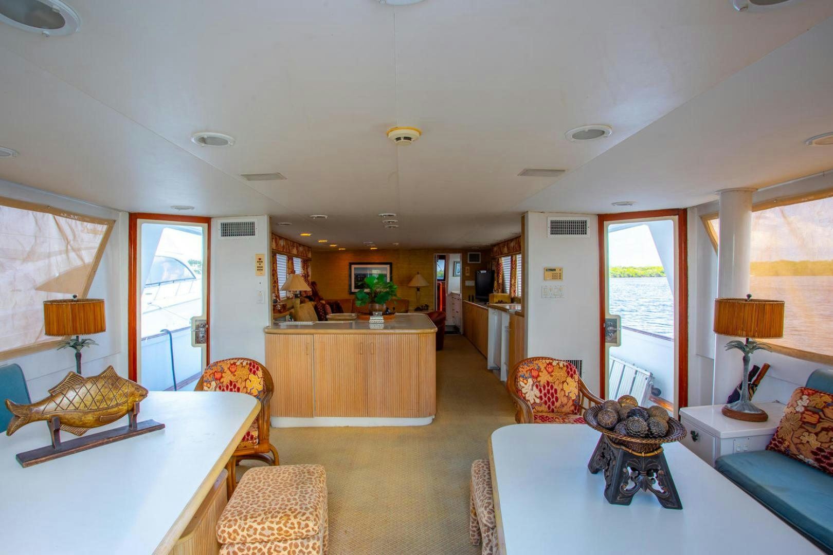 a living room with a kitchen and dining area aboard HIGH MILEAGE Yacht for Sale