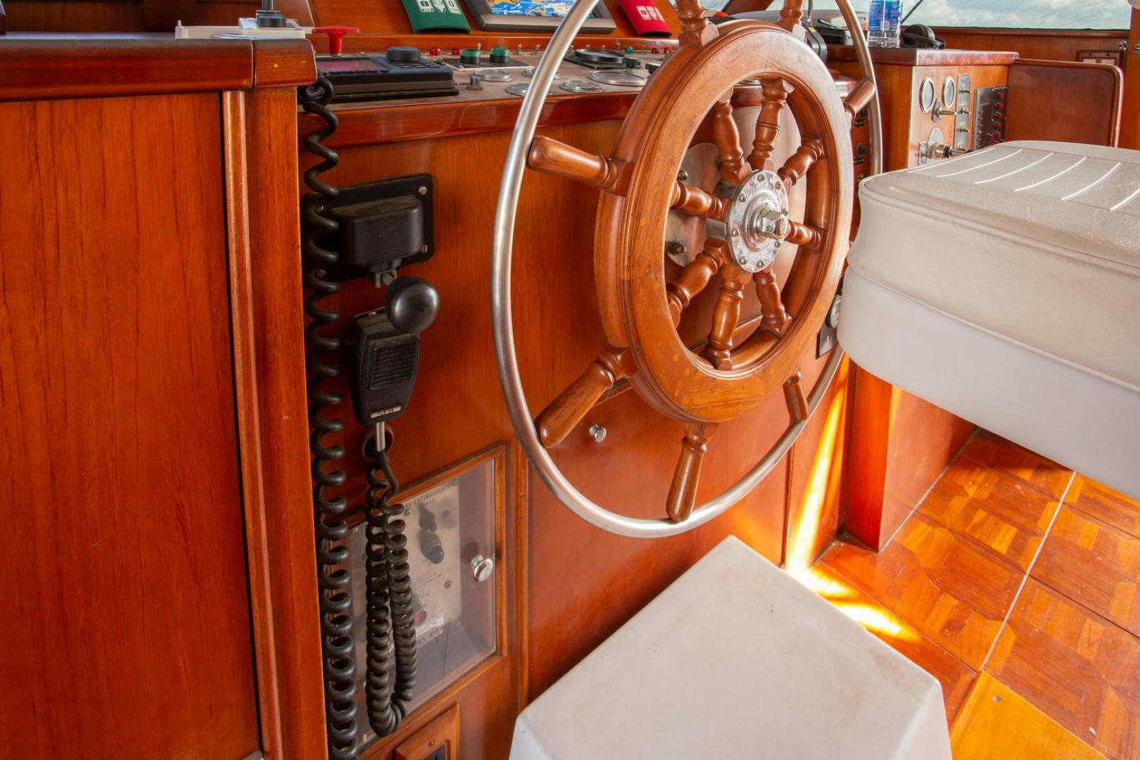 a wooden wheel with a wooden handle aboard HIGH MILEAGE Yacht for Sale
