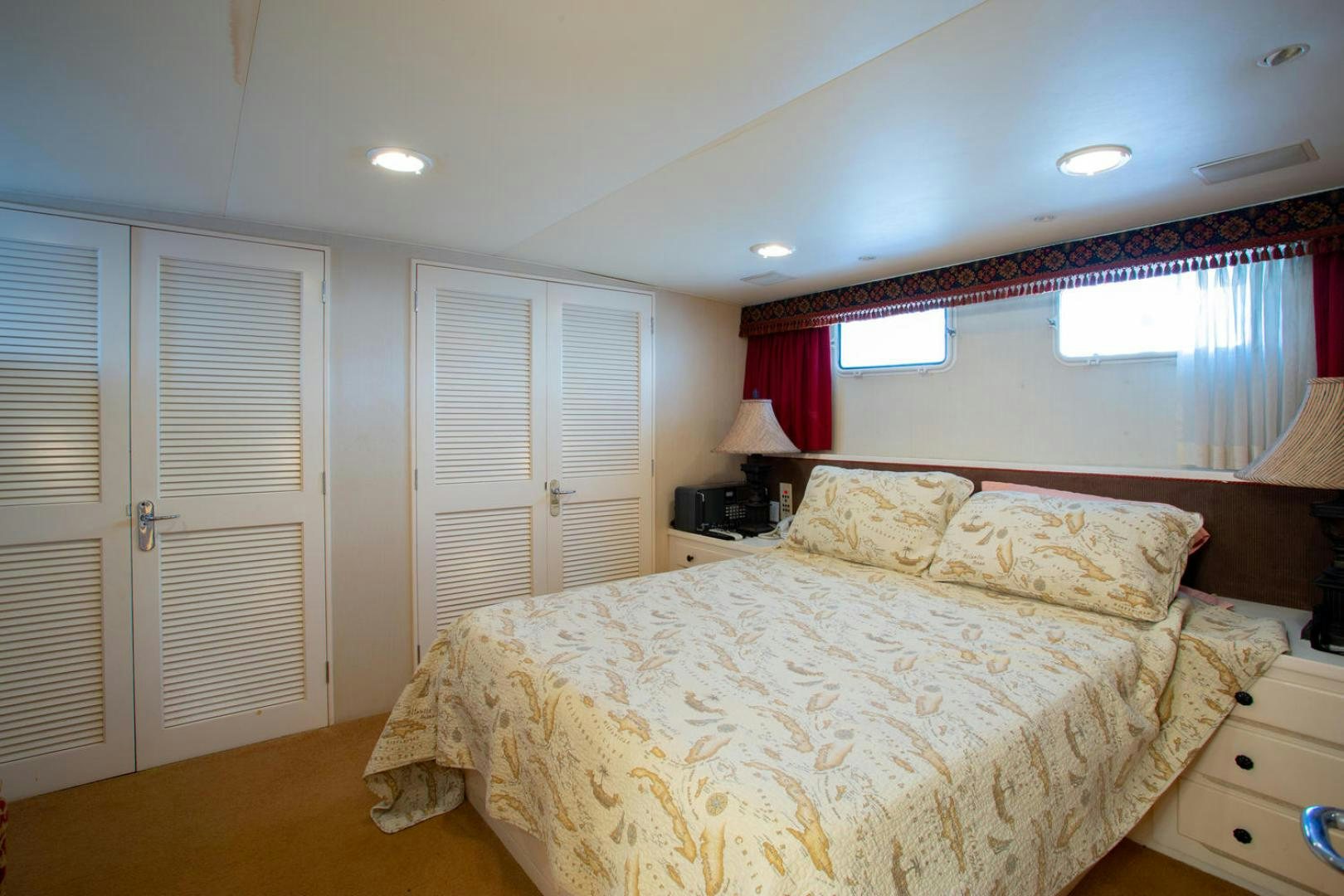 a bedroom with a bed and a window aboard HIGH MILEAGE Yacht for Sale