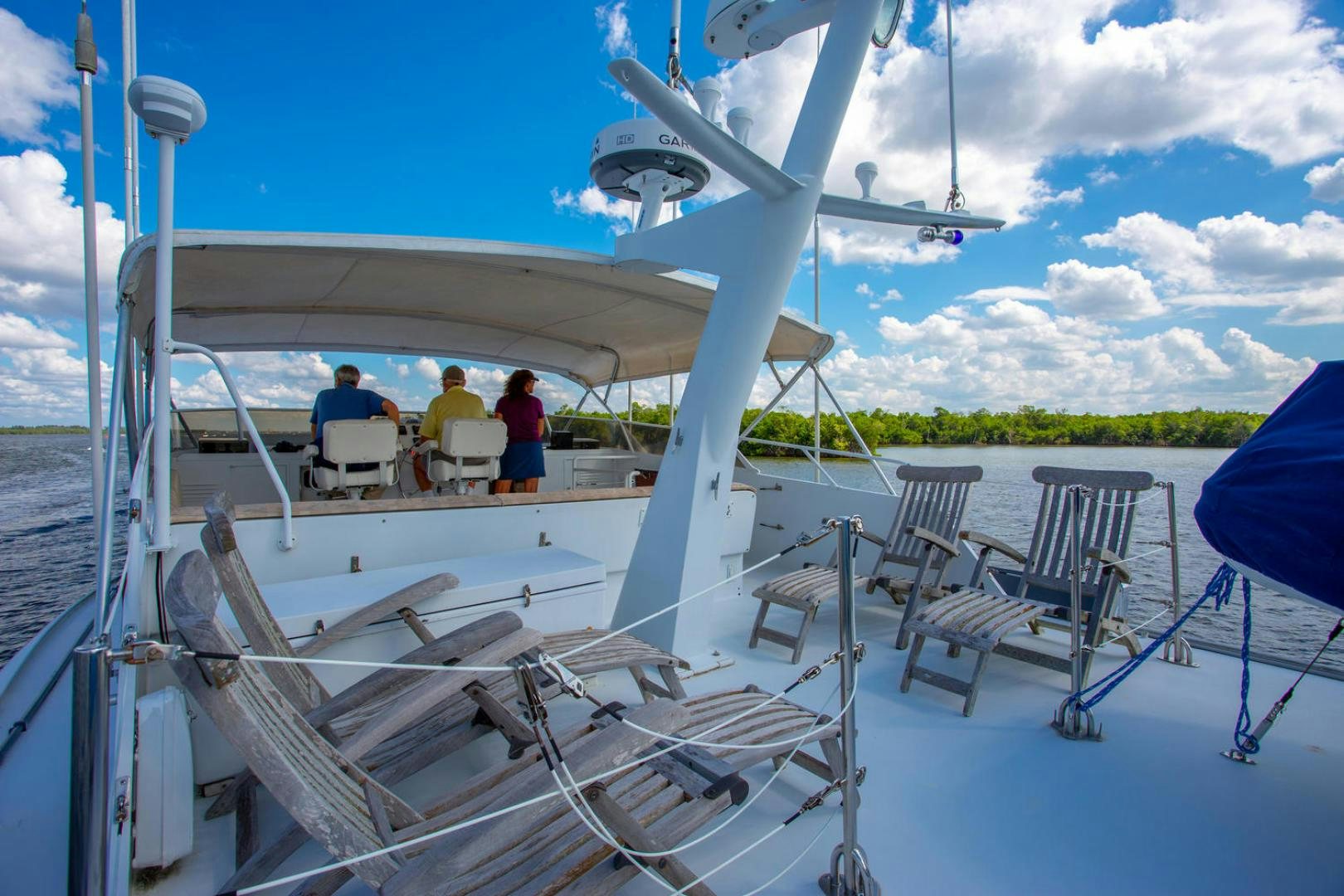 a group of people sitting on a boat aboard HIGH MILEAGE Yacht for Sale