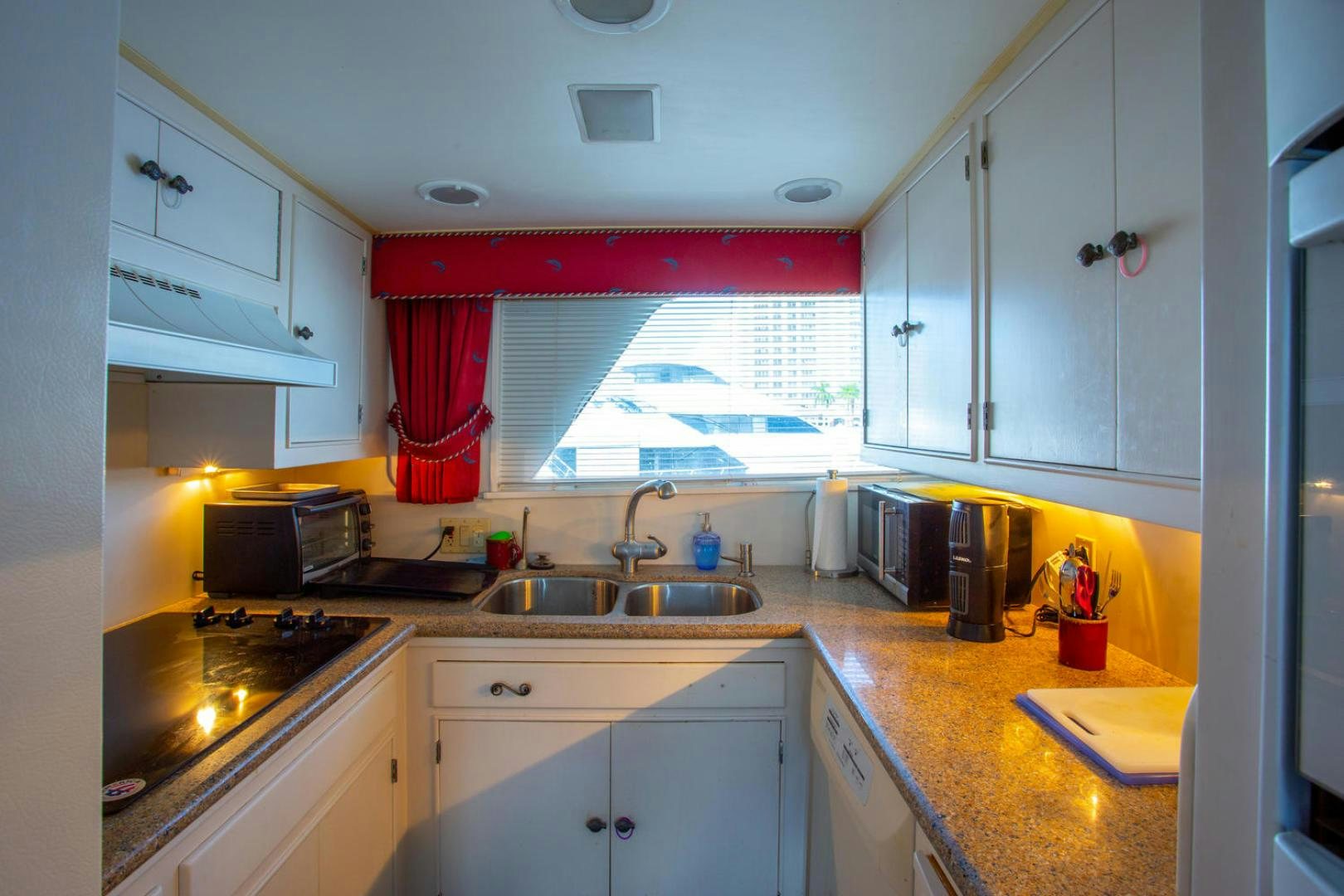 a kitchen with white cabinets aboard HIGH MILEAGE Yacht for Sale