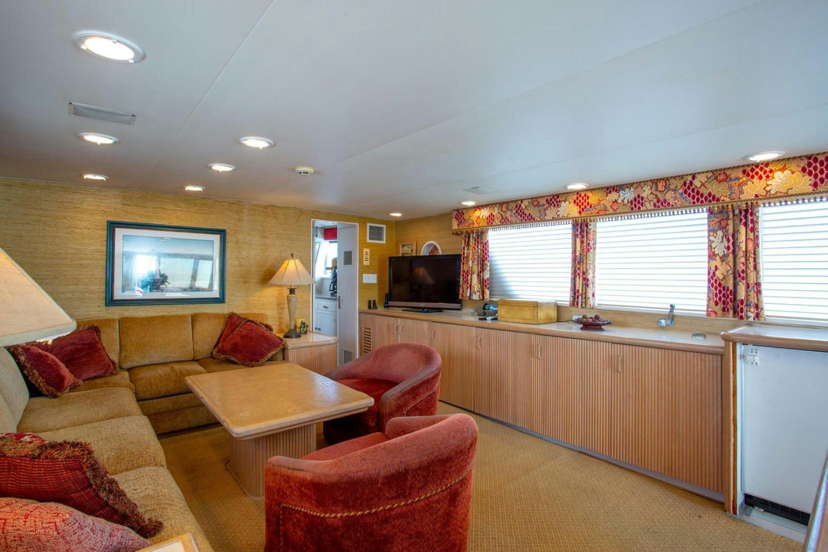 a living room with a couch and a television aboard HIGH MILEAGE Yacht for Sale