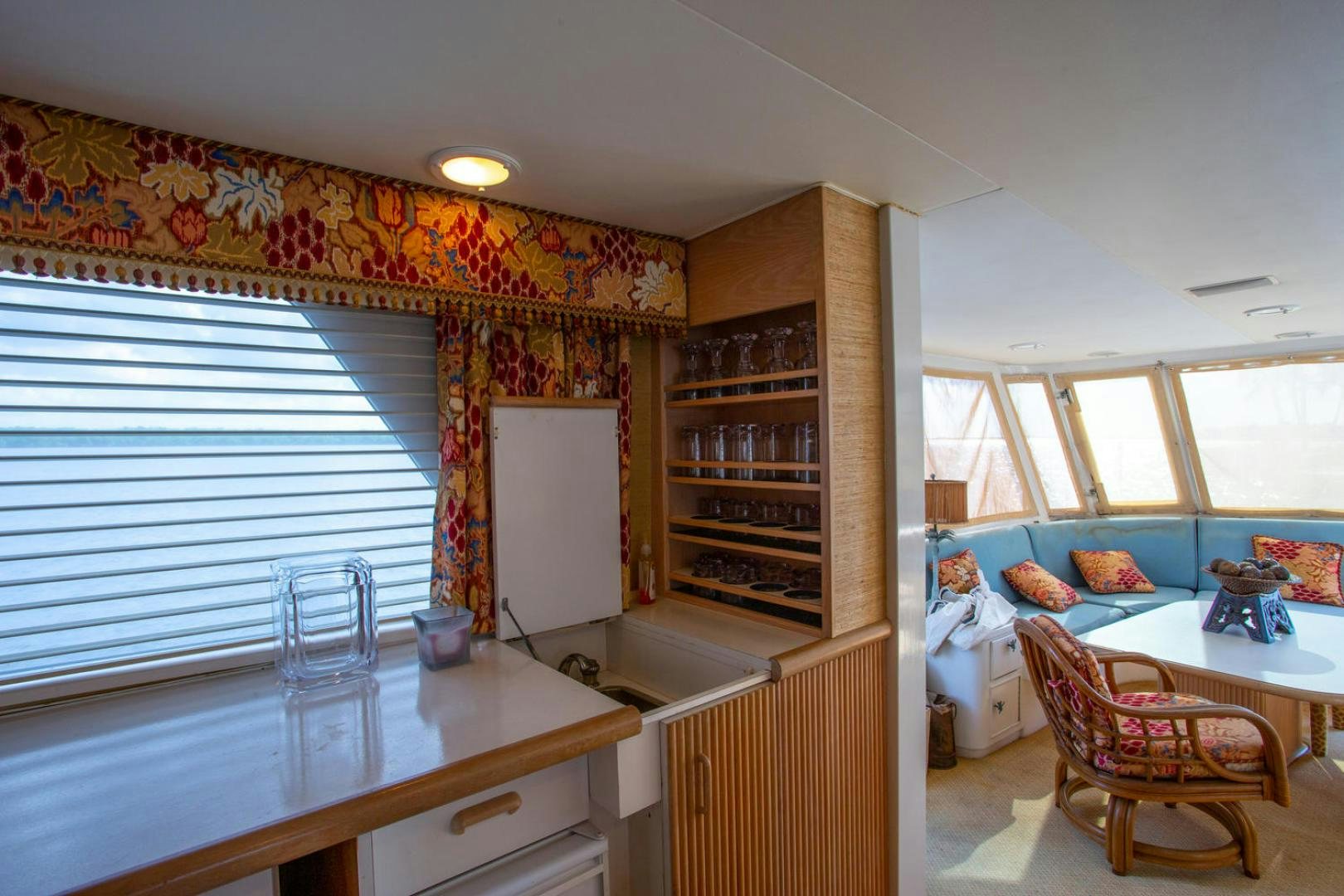 a kitchen with a table and chairs aboard HIGH MILEAGE Yacht for Sale