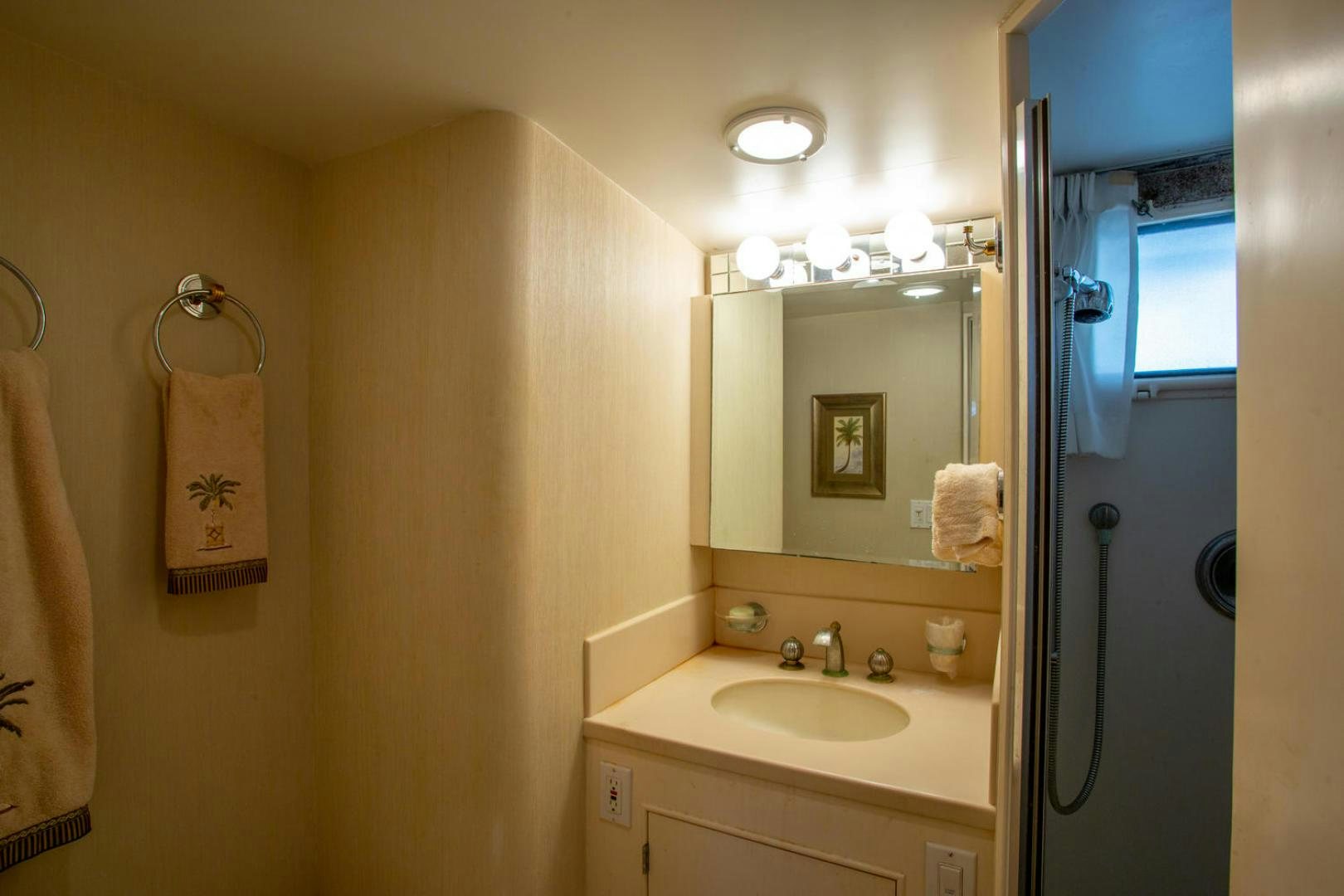 a bathroom with a sink and mirror aboard HIGH MILEAGE Yacht for Sale