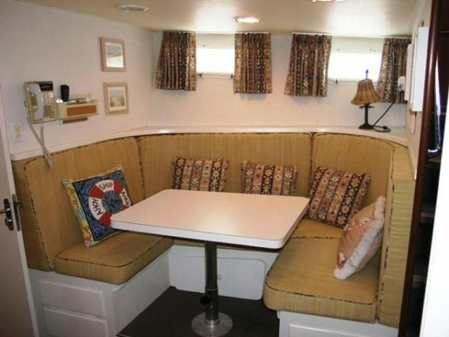 a living room with a couch and a table aboard HIGH MILEAGE Yacht for Sale