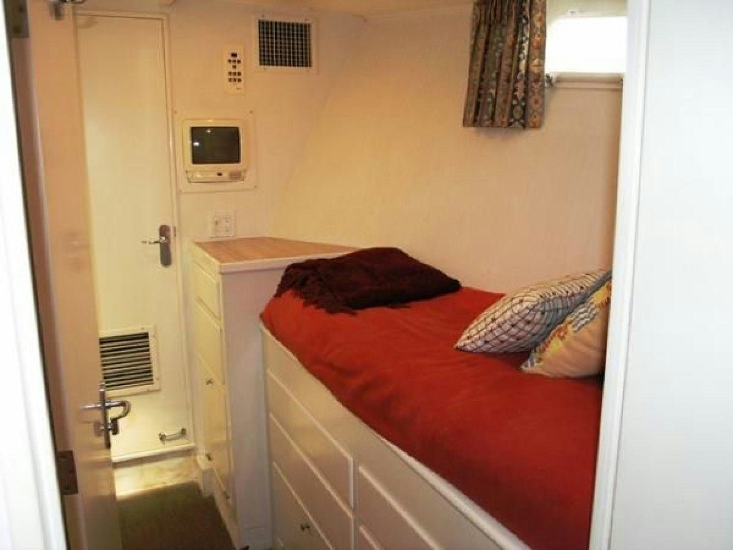 a bed in a room aboard HIGH MILEAGE Yacht for Sale