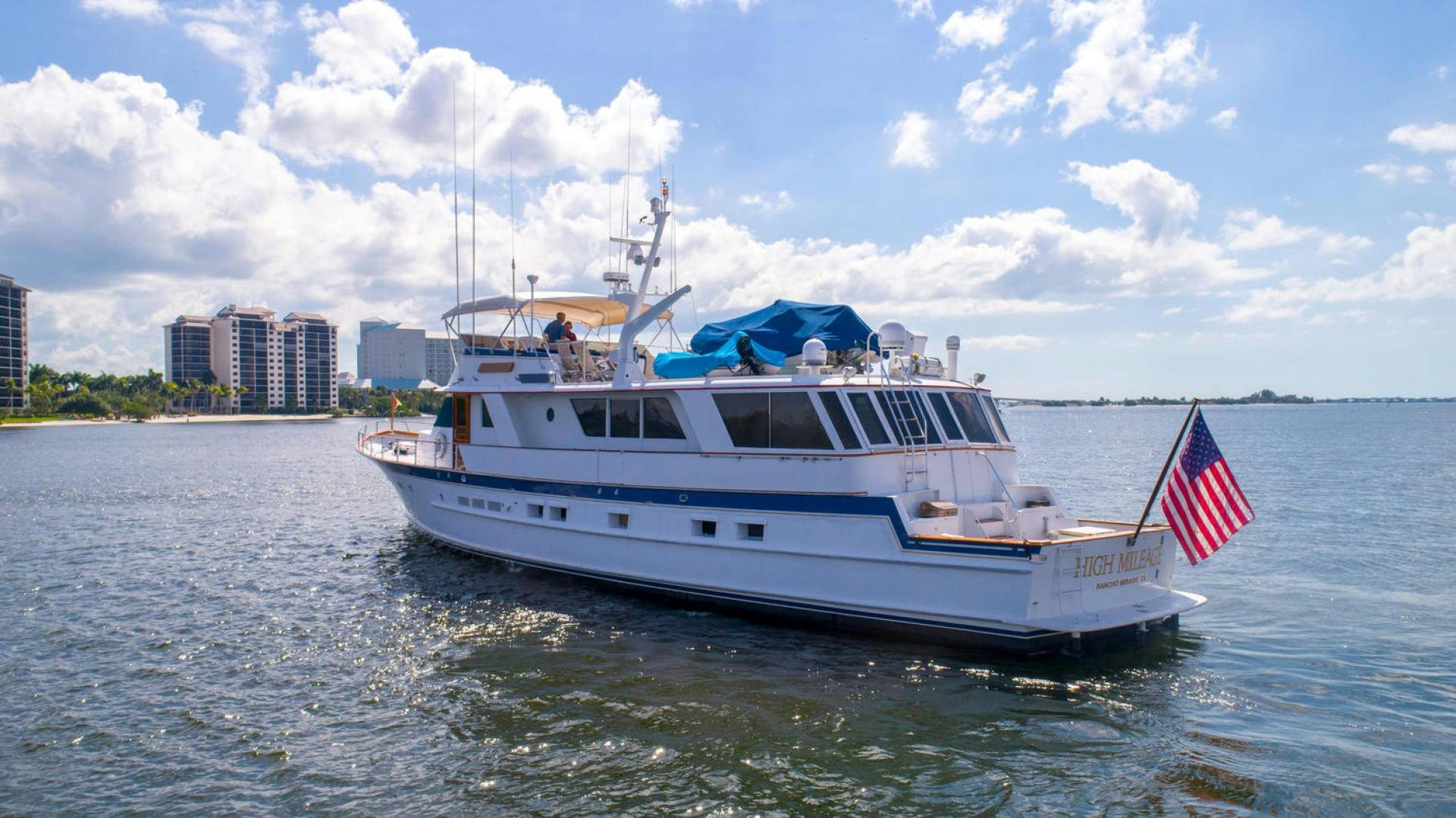 a boat with a flag on the front aboard HIGH MILEAGE Yacht for Sale