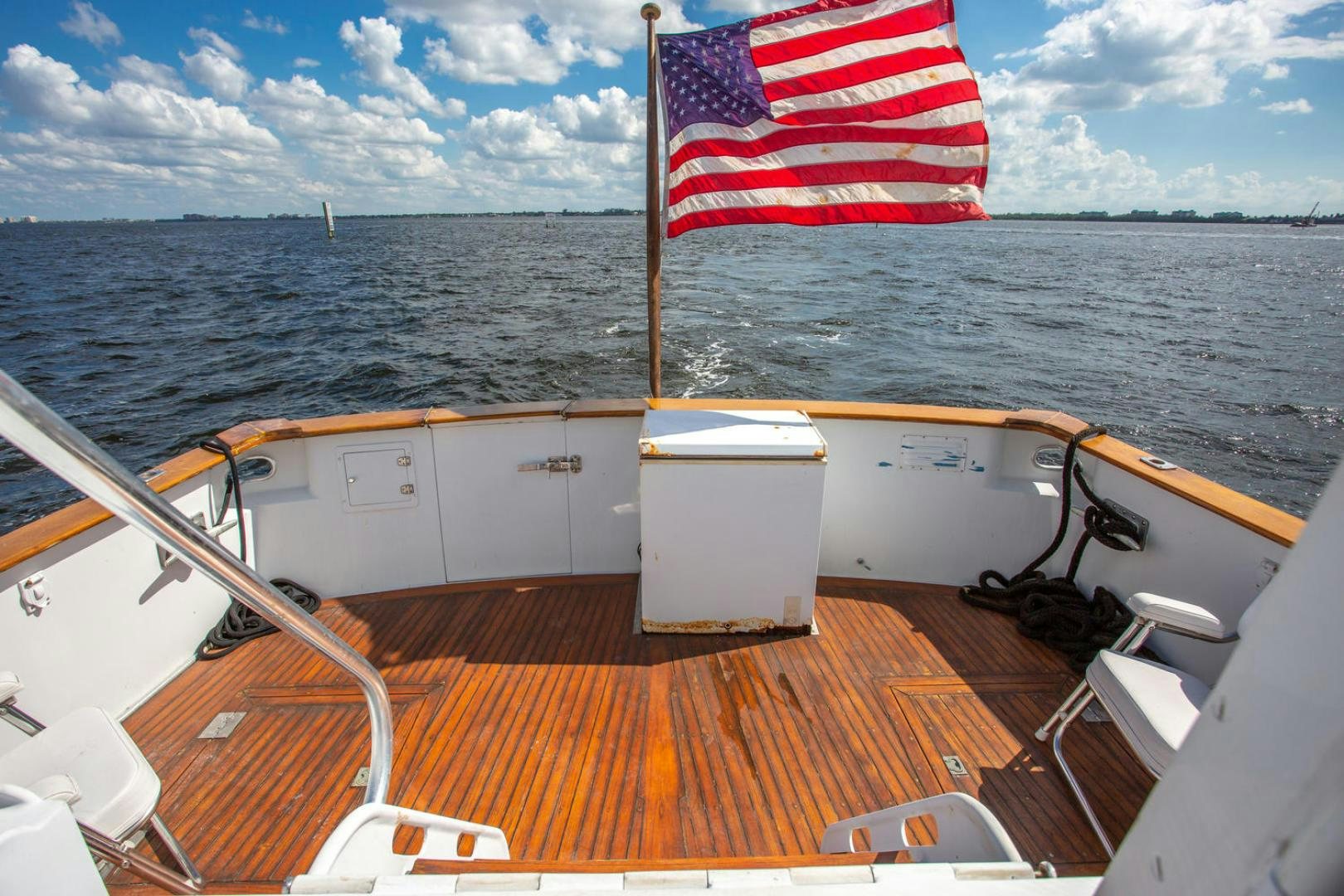 a boat with a flag on the front aboard HIGH MILEAGE Yacht for Sale