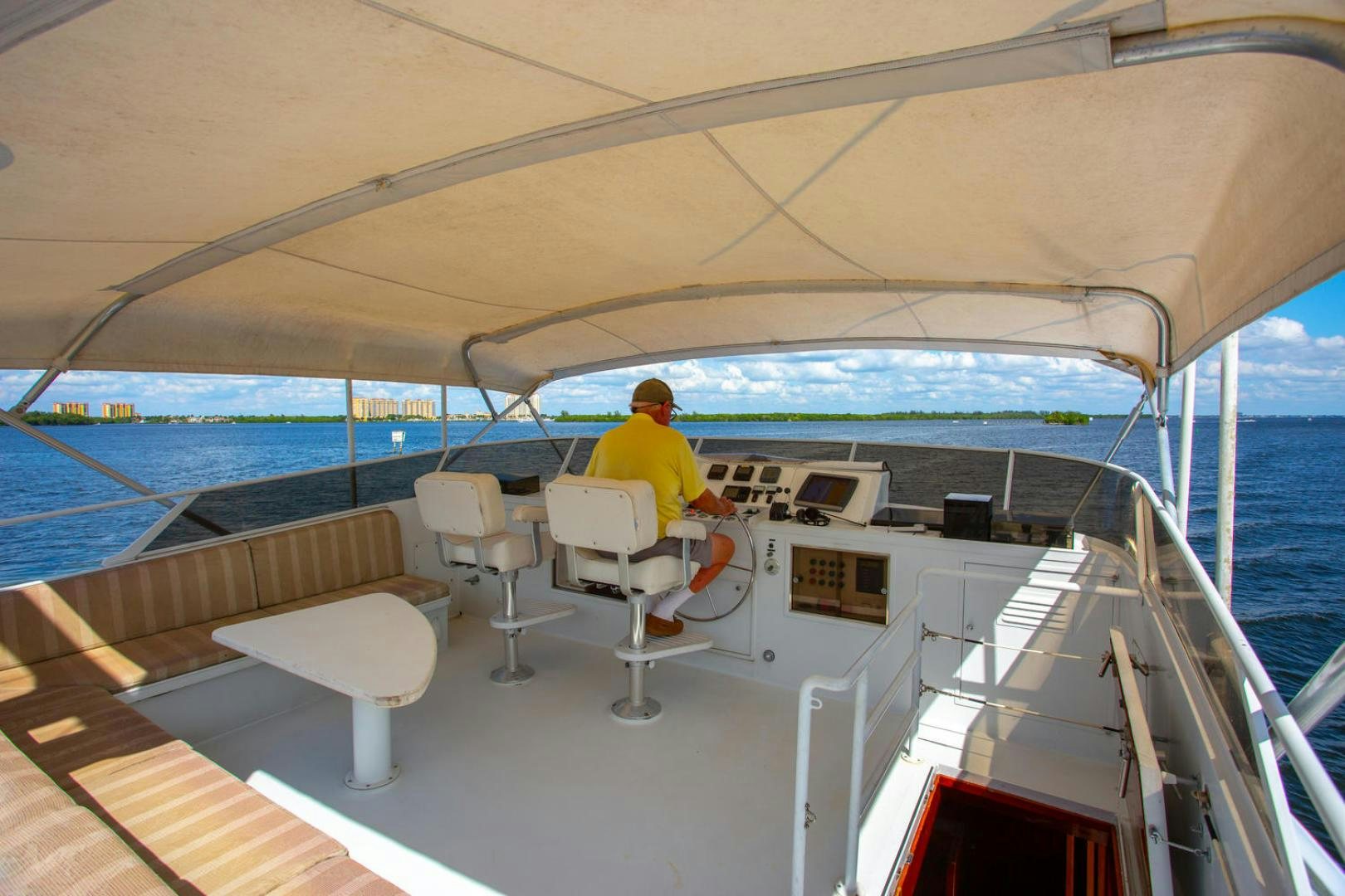 a person sitting on a boat aboard HIGH MILEAGE Yacht for Sale