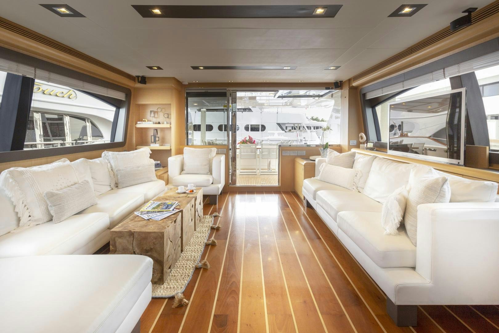 a living room with a wood floor aboard LA PACE Yacht for Sale