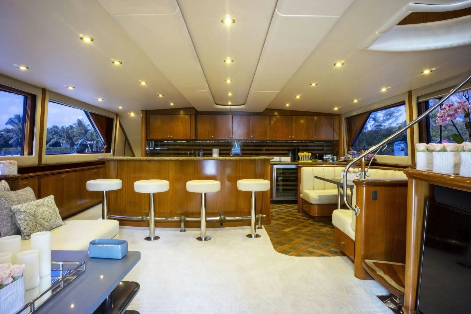 a room with a piano and stools aboard REEL DEAL Yacht for Sale