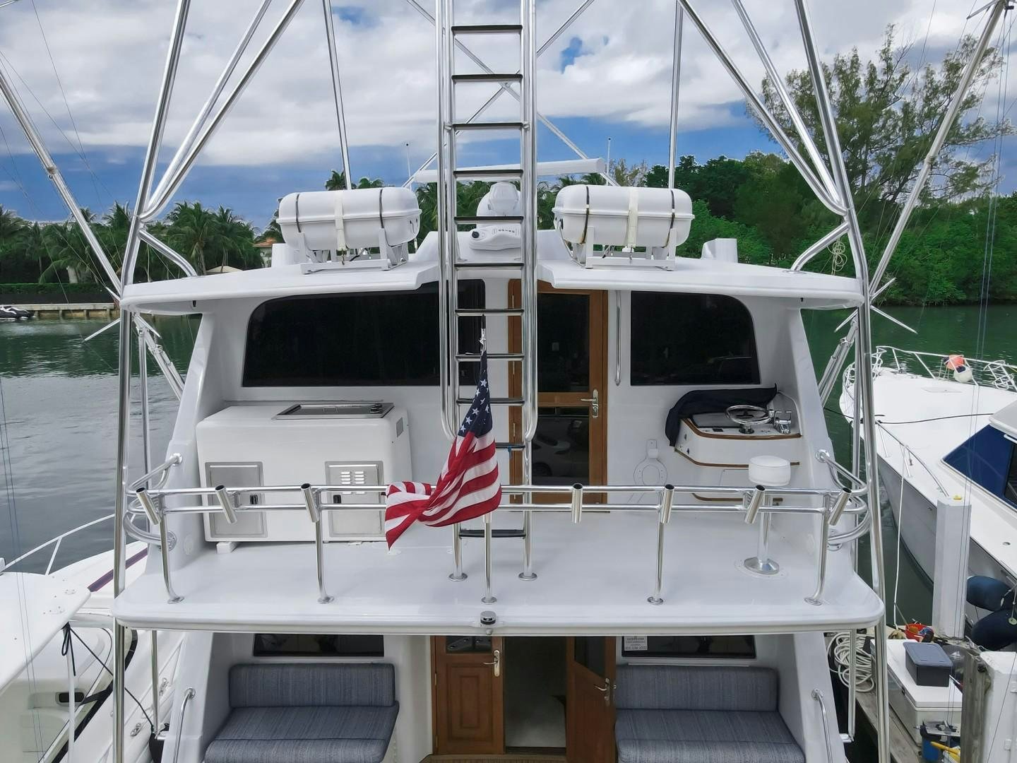 a boat with a flag on the front aboard REEL DEAL Yacht for Sale