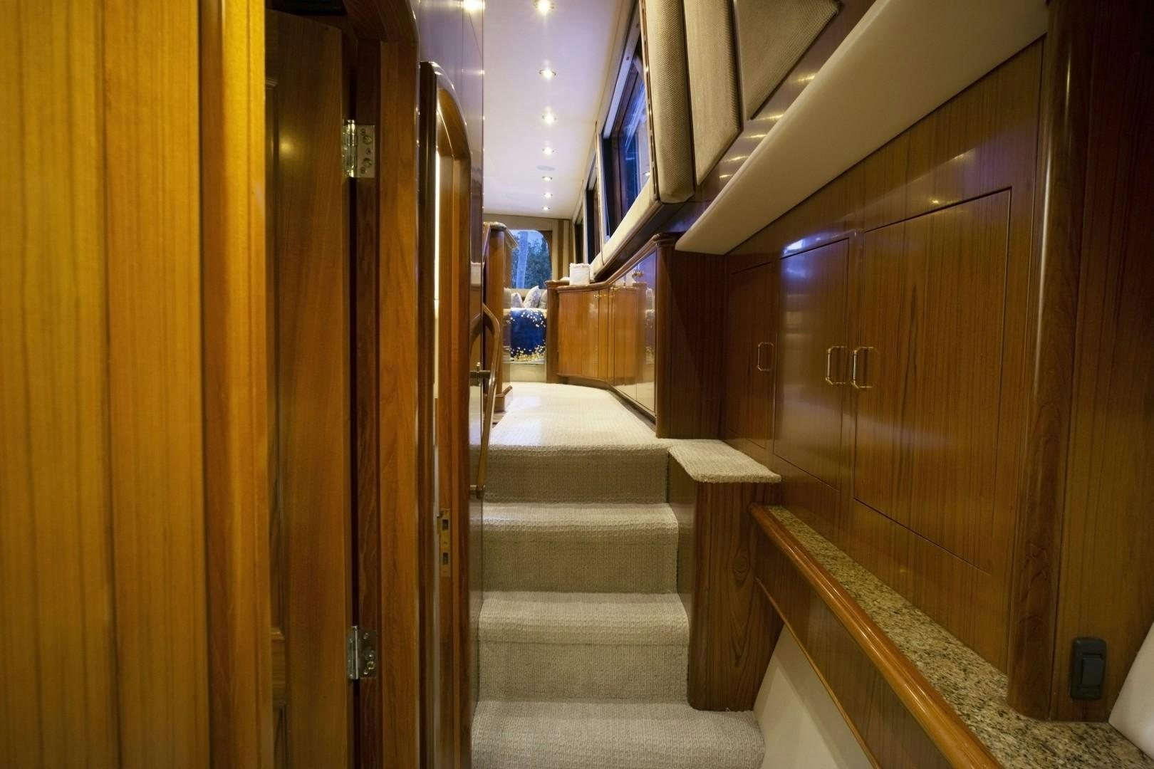 a hallway with wooden doors aboard REEL DEAL Yacht for Sale