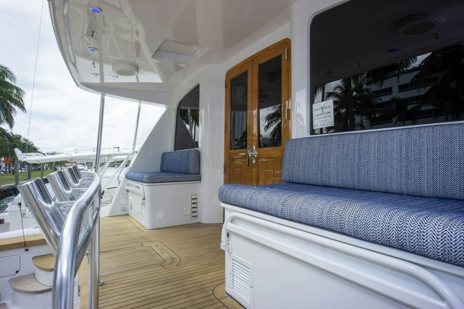 a living room with a couch and a table aboard REEL DEAL Yacht for Sale