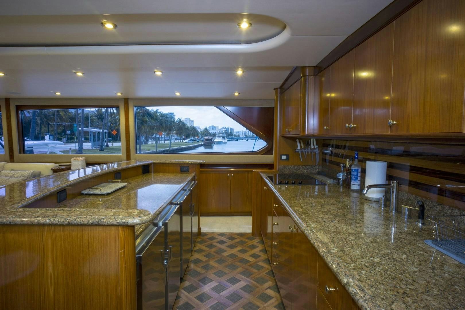 a kitchen with a bar and countertop sinks aboard REEL DEAL Yacht for Sale