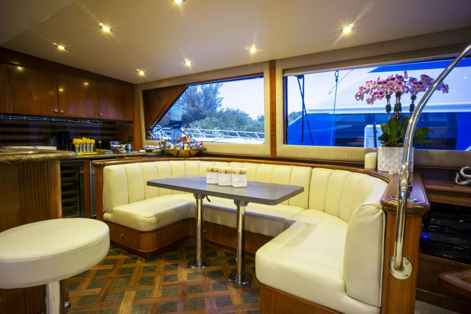 a kitchen with a table and chairs aboard REEL DEAL Yacht for Sale
