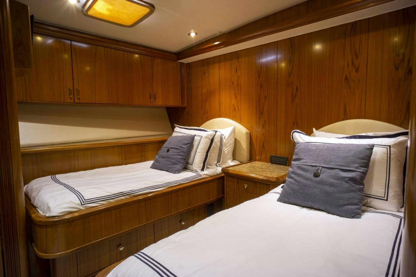 a couple of beds in a room aboard REEL DEAL Yacht for Sale